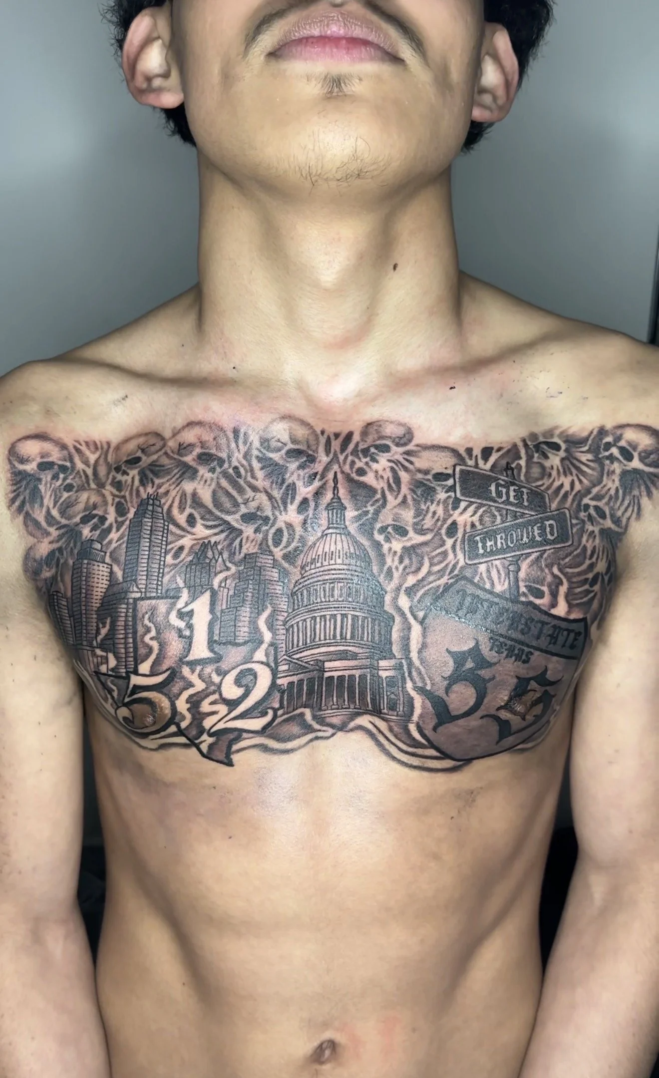Chest piece tattoo done in black and grey by Oscar 