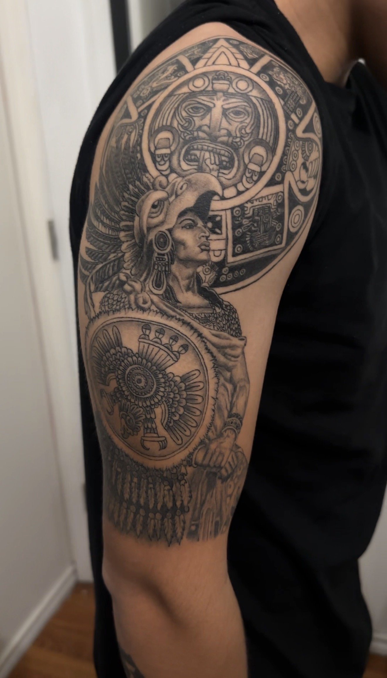 Aztec calendar and warrior tattoo done in black and grey by Oscar 