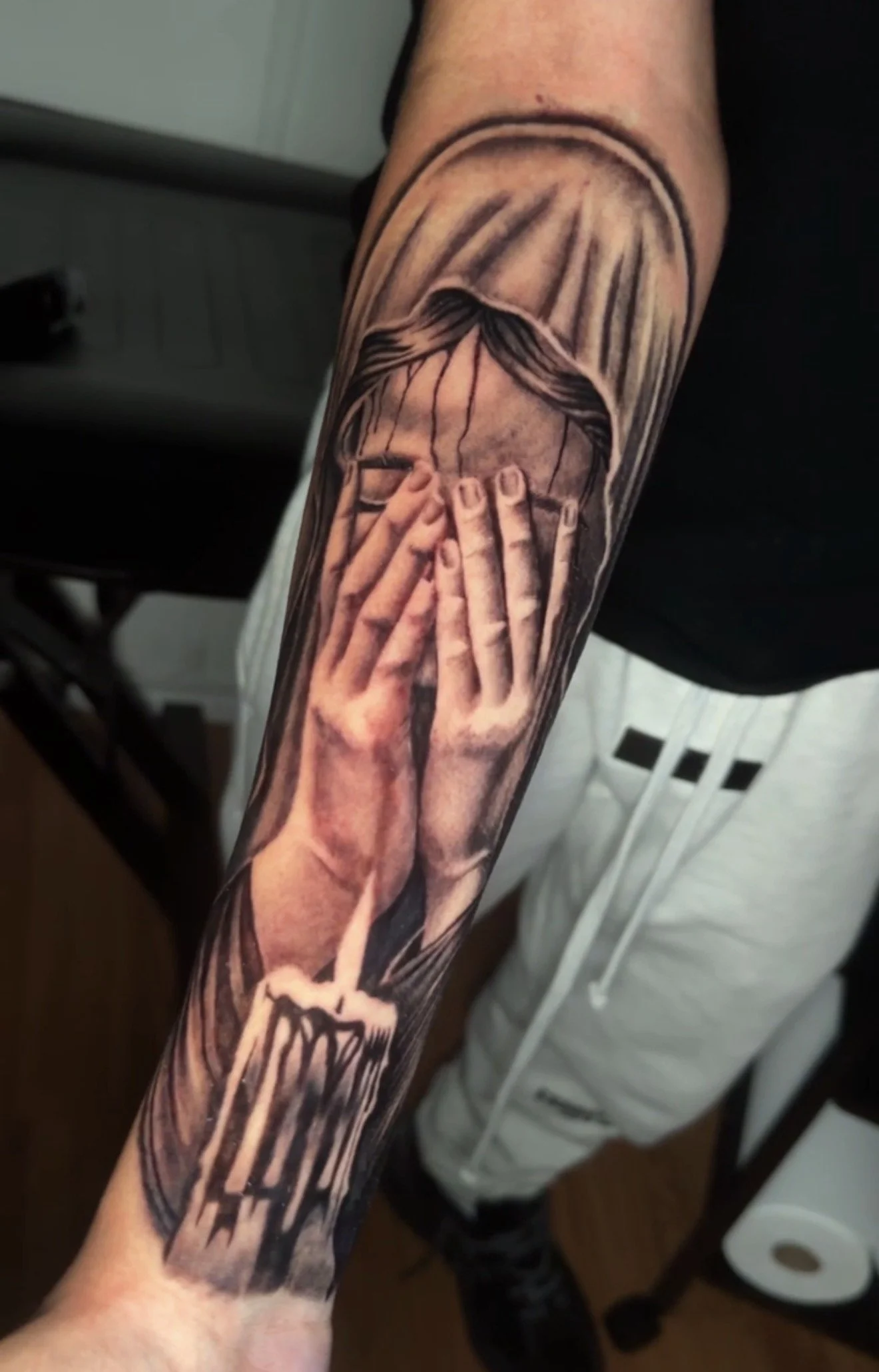 Crying virgin Mary tattoo done in black and grey realism by Oscar 