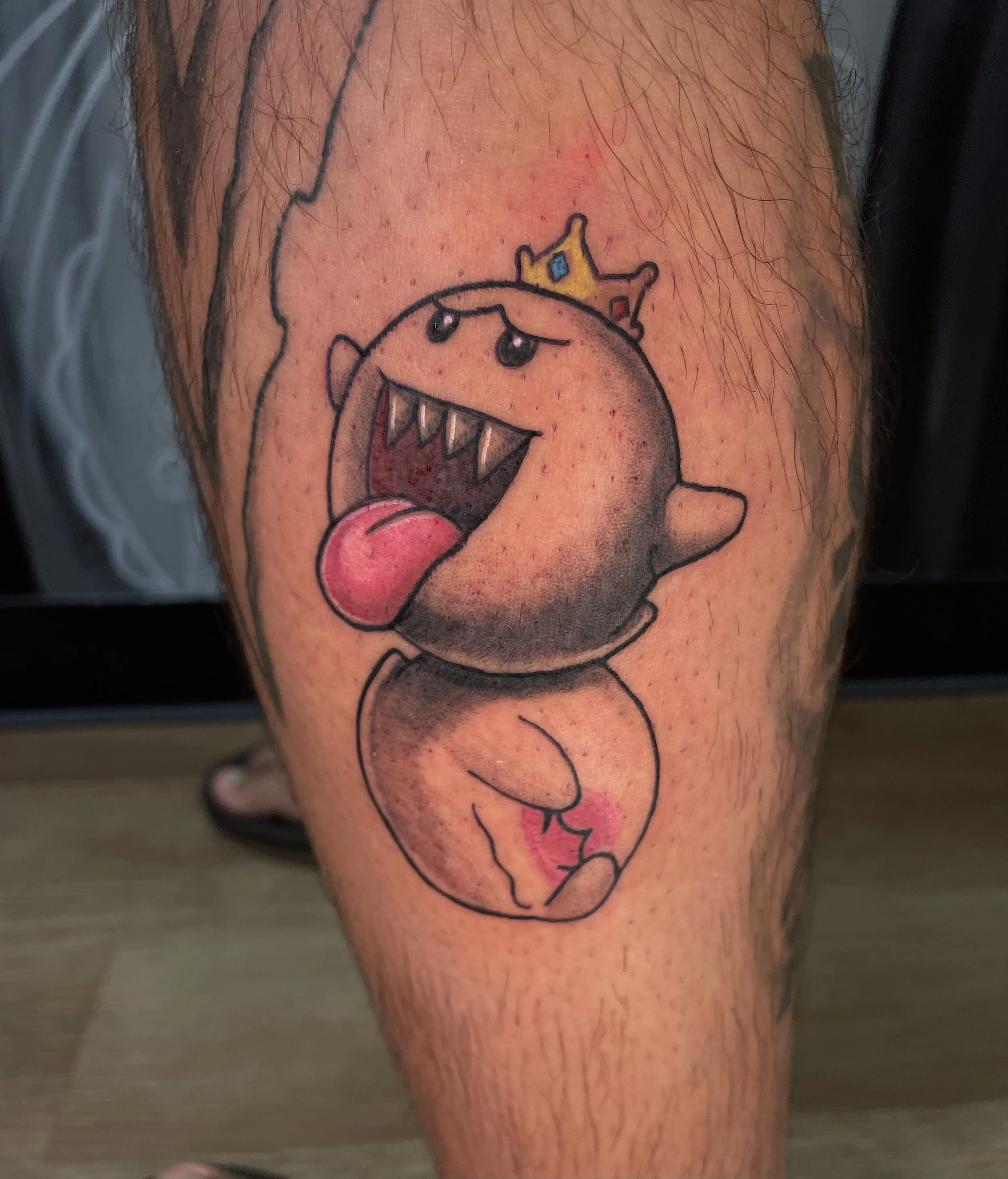 KIng Boo tattoo from Mario Kart or Mario Party. Color tattoos on darker skin.