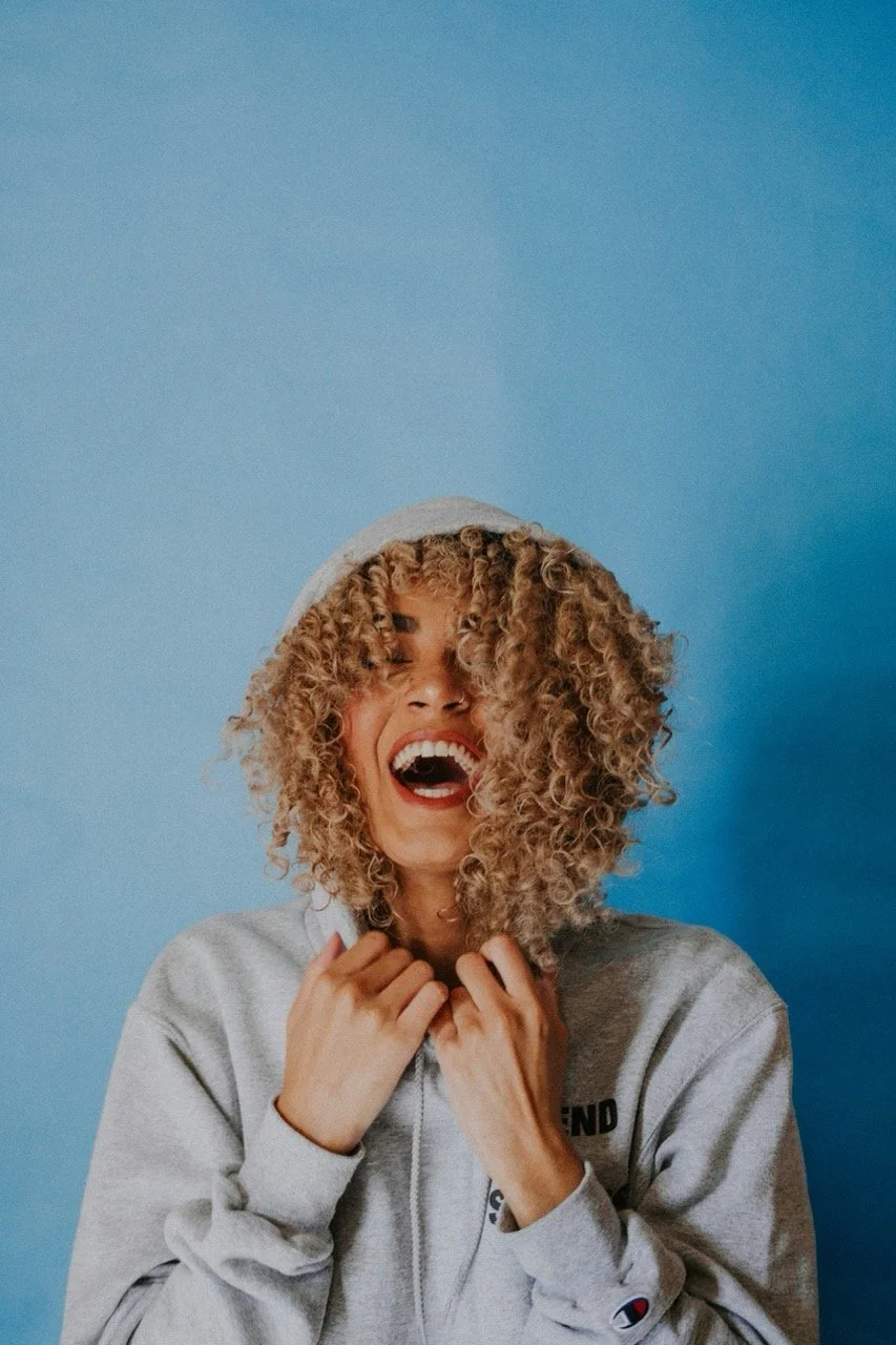 Laughing woman in a hoodie