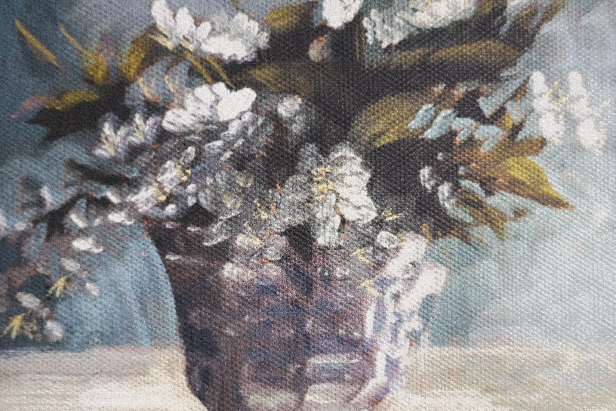 Close-up of a floral textile fabric with large white and dark purple flowers and green leaves.