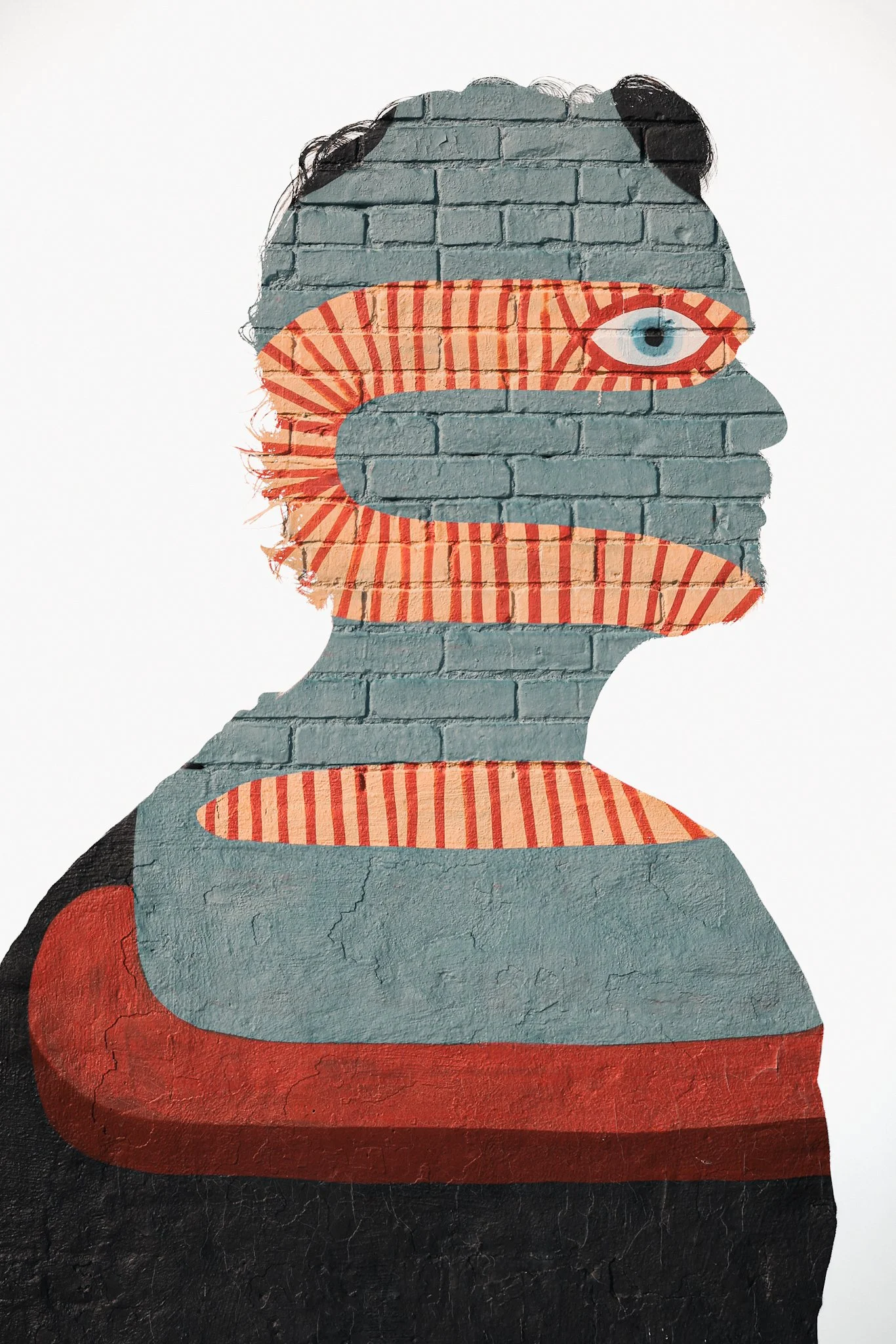 Double‑exposed profile of a person painted on a brick wall, with teal, red, and cream stripes creating a surreal face and torso, revealing the wall’s texture and cracks against a white background.