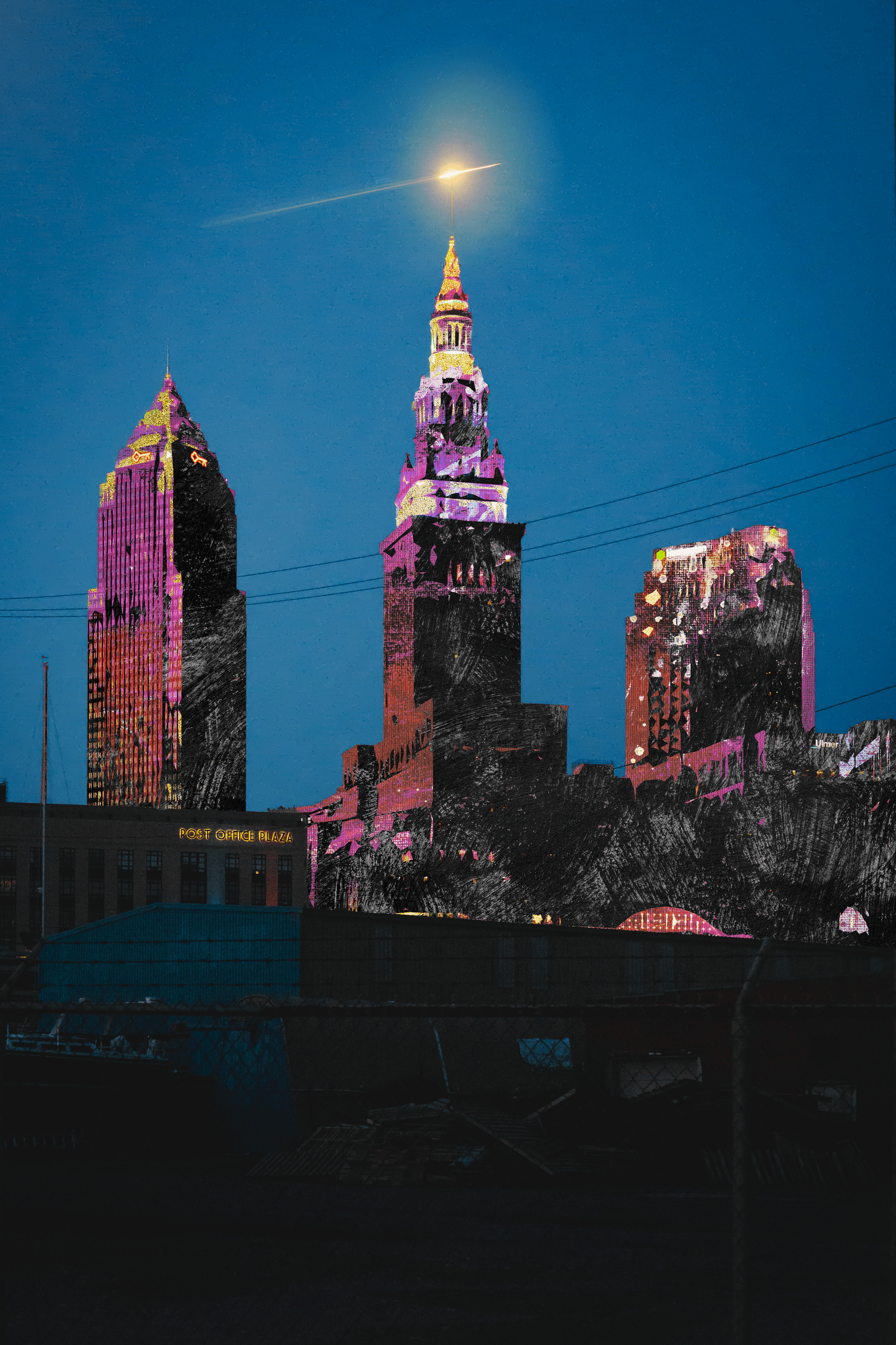 Nighttime image of a city skyline with three tall buildings illuminated in pink and purple. The sky is dark blue, and a comet or meteor is visible with a bright trail at the top of the central building.