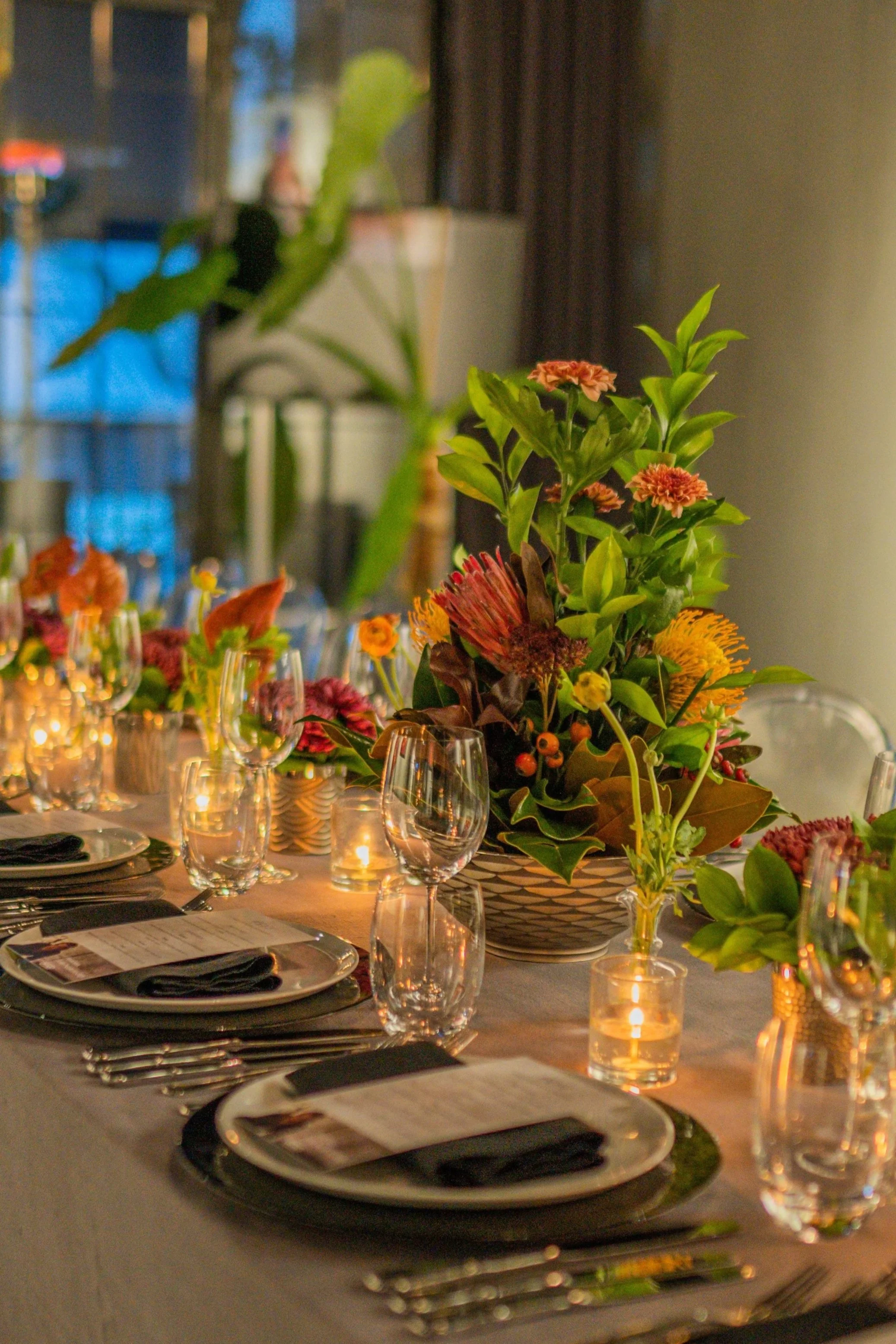 Leadership Ownership: a candlelit private dinner table with flowers