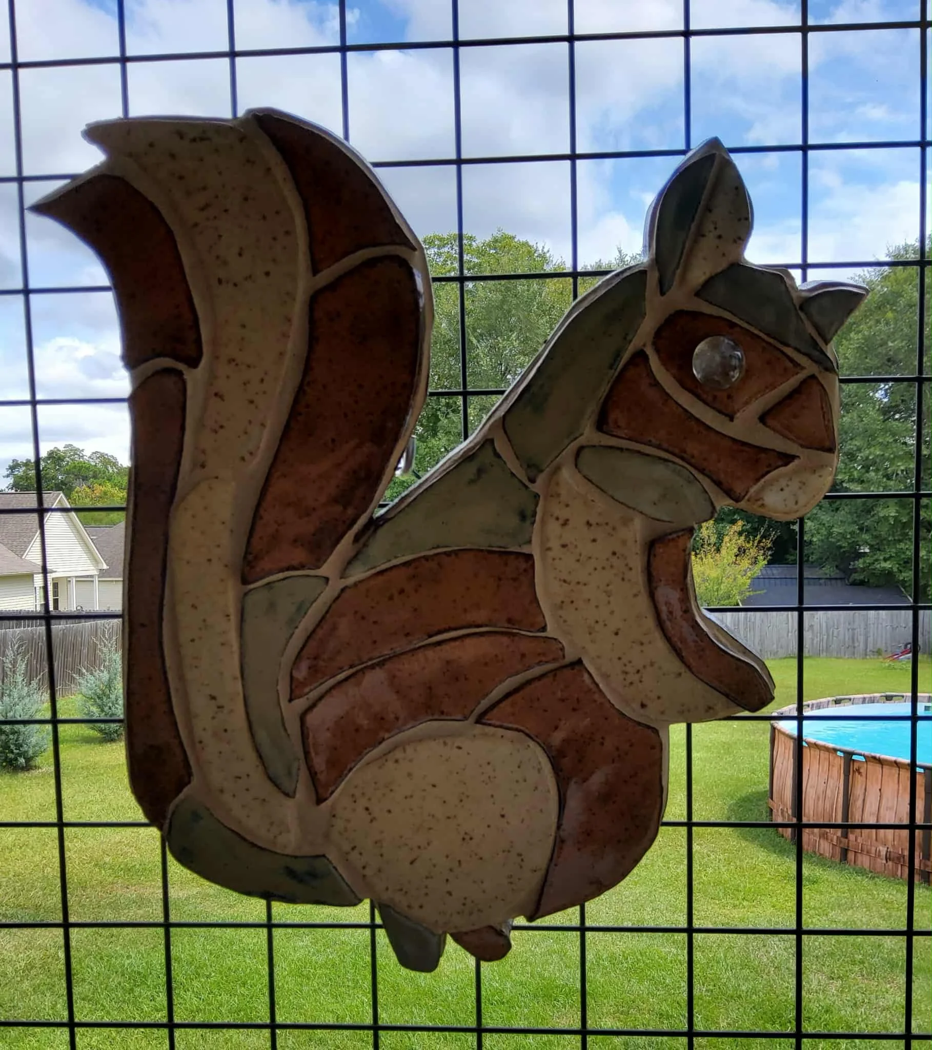 Burl the Squirrell $95 Size is 15" wide x 15" high. Made of ceramic tile backed with wood for hanging