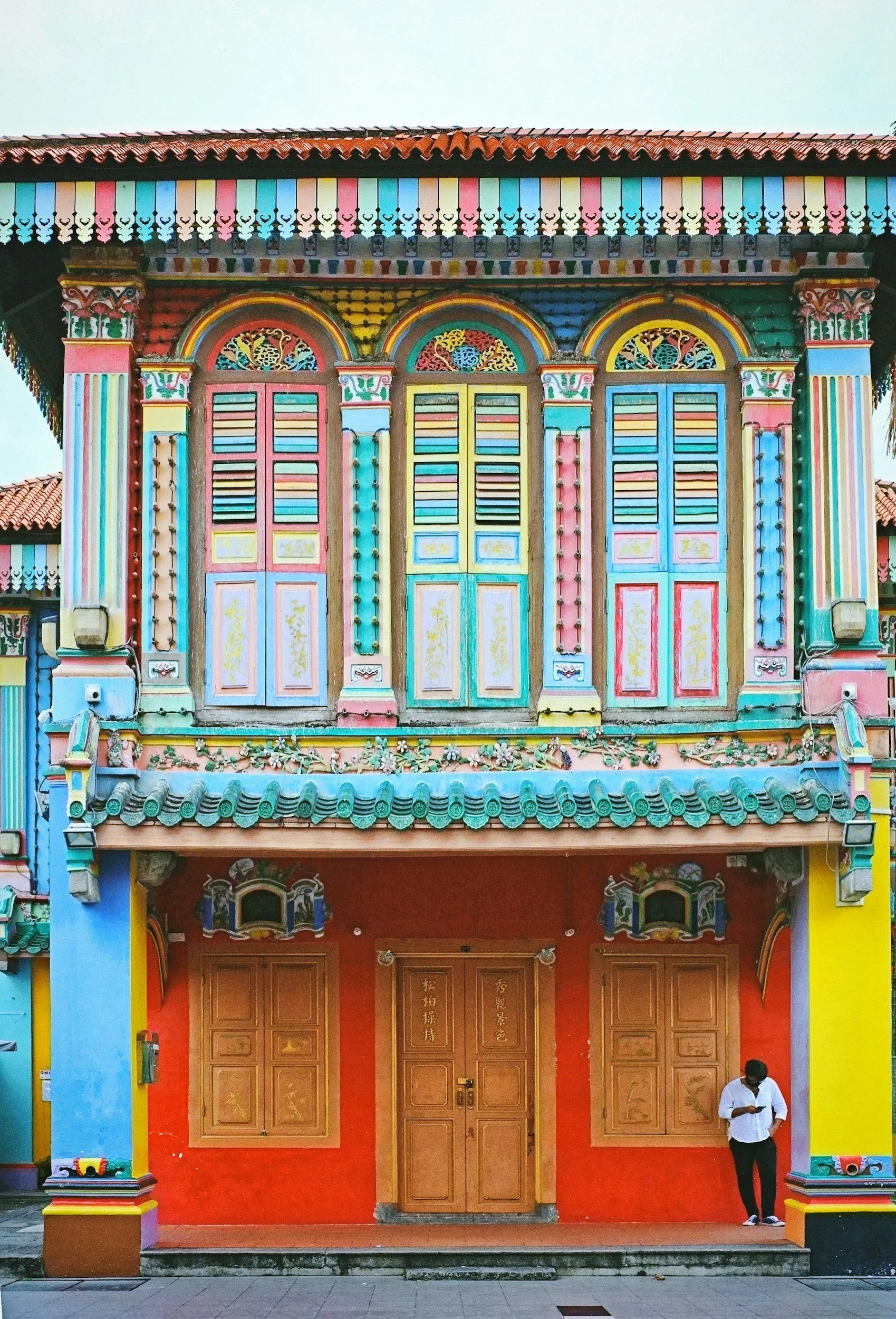 Man standing outside a bright shopfront in Little India