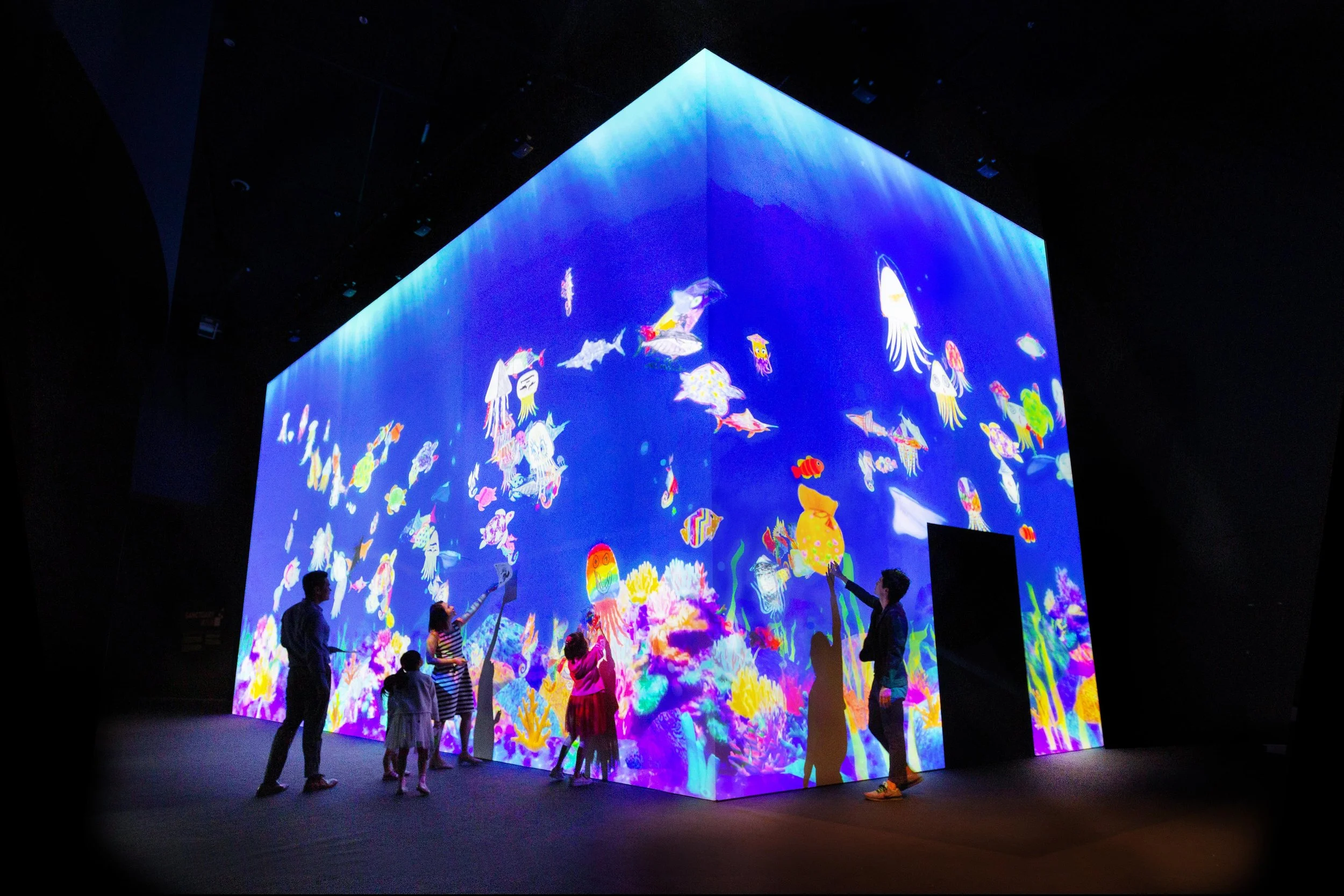 Large interactive aquarium that has people touching it