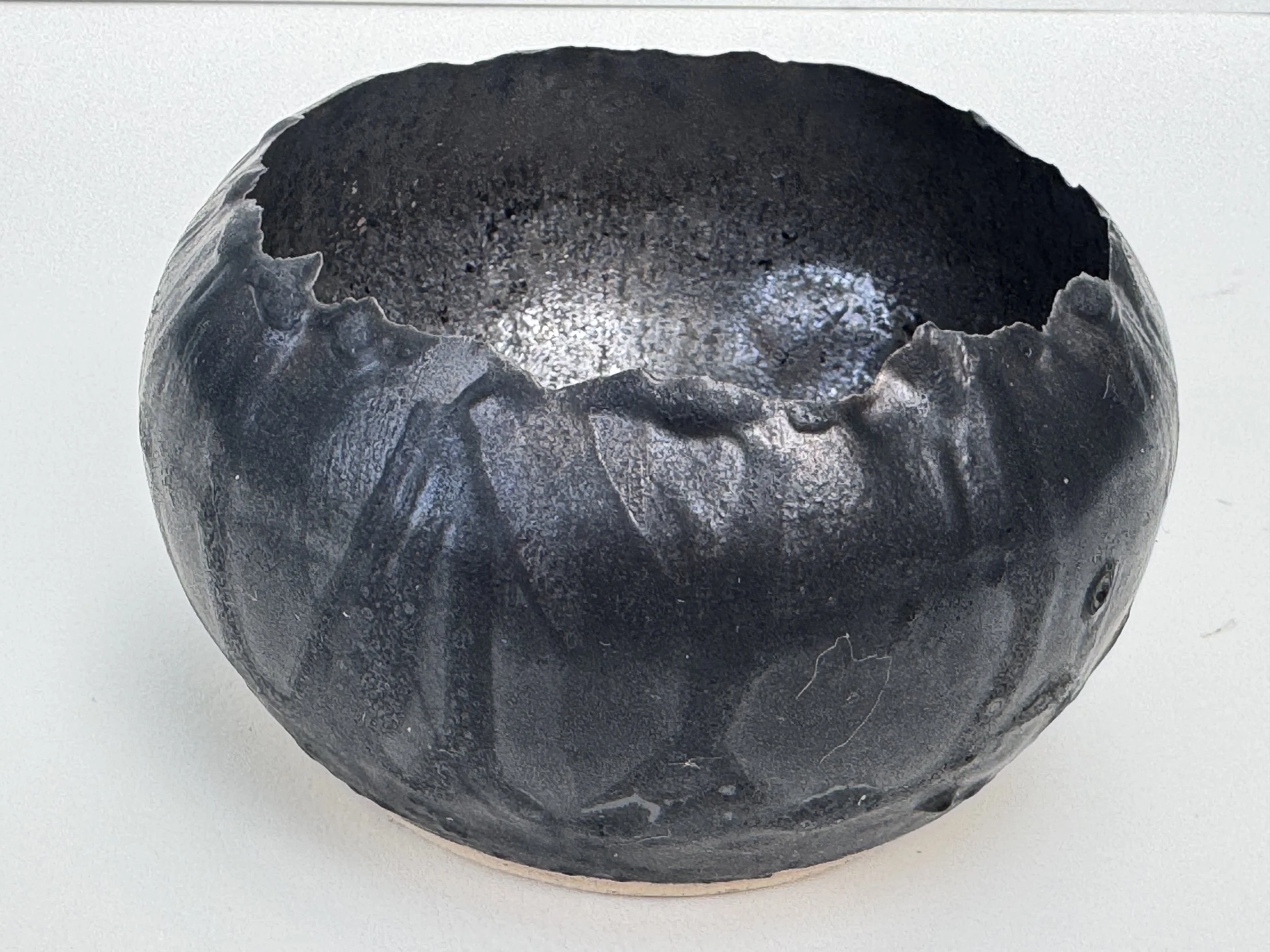 Small elegant sculptural bowl, designed for functional or decorative use, white clay, glazed in anthracite outer and antique gold inner, it almost has a metallic feel to it, from the depths of the earth. 20cms diameter and 15cms high.