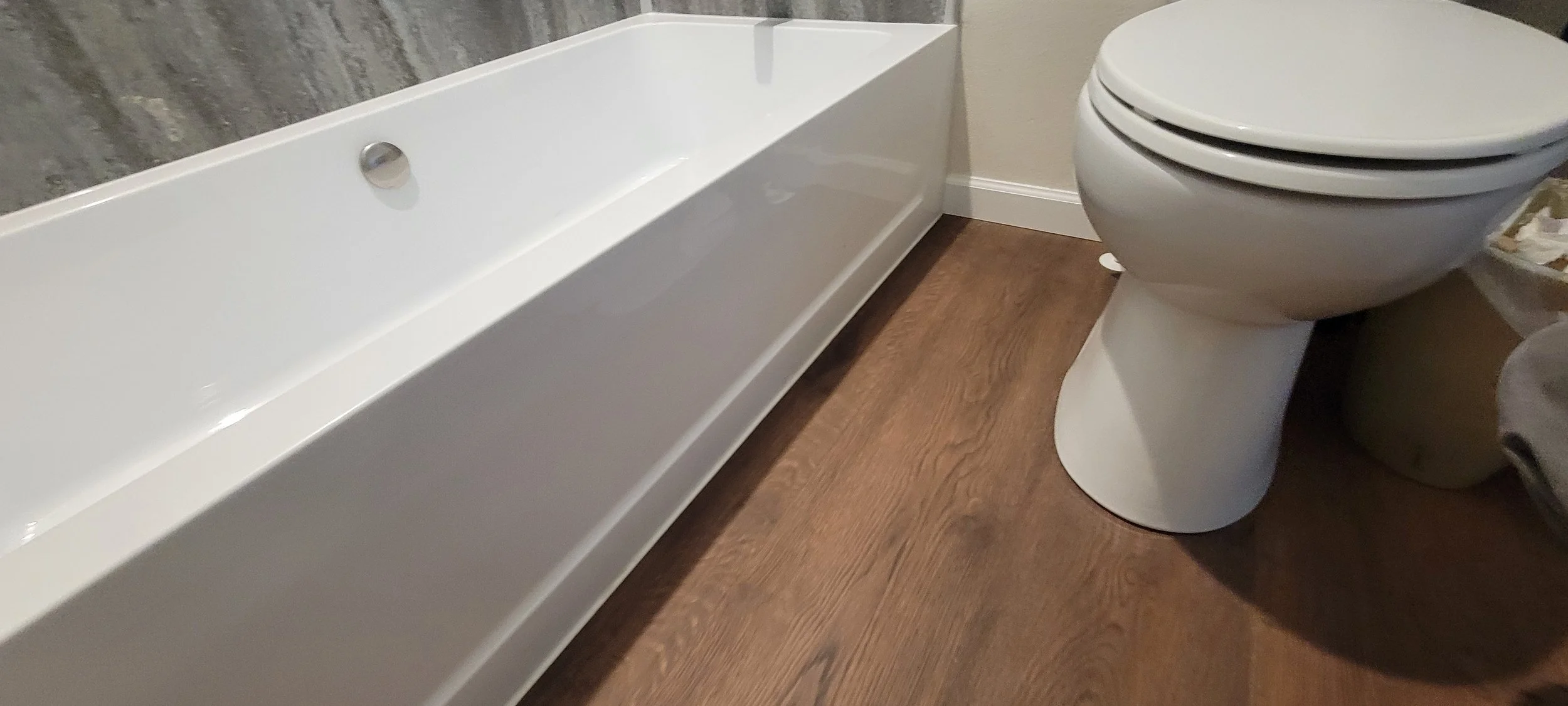 Sleek new bathtub with modern faux slate surround.