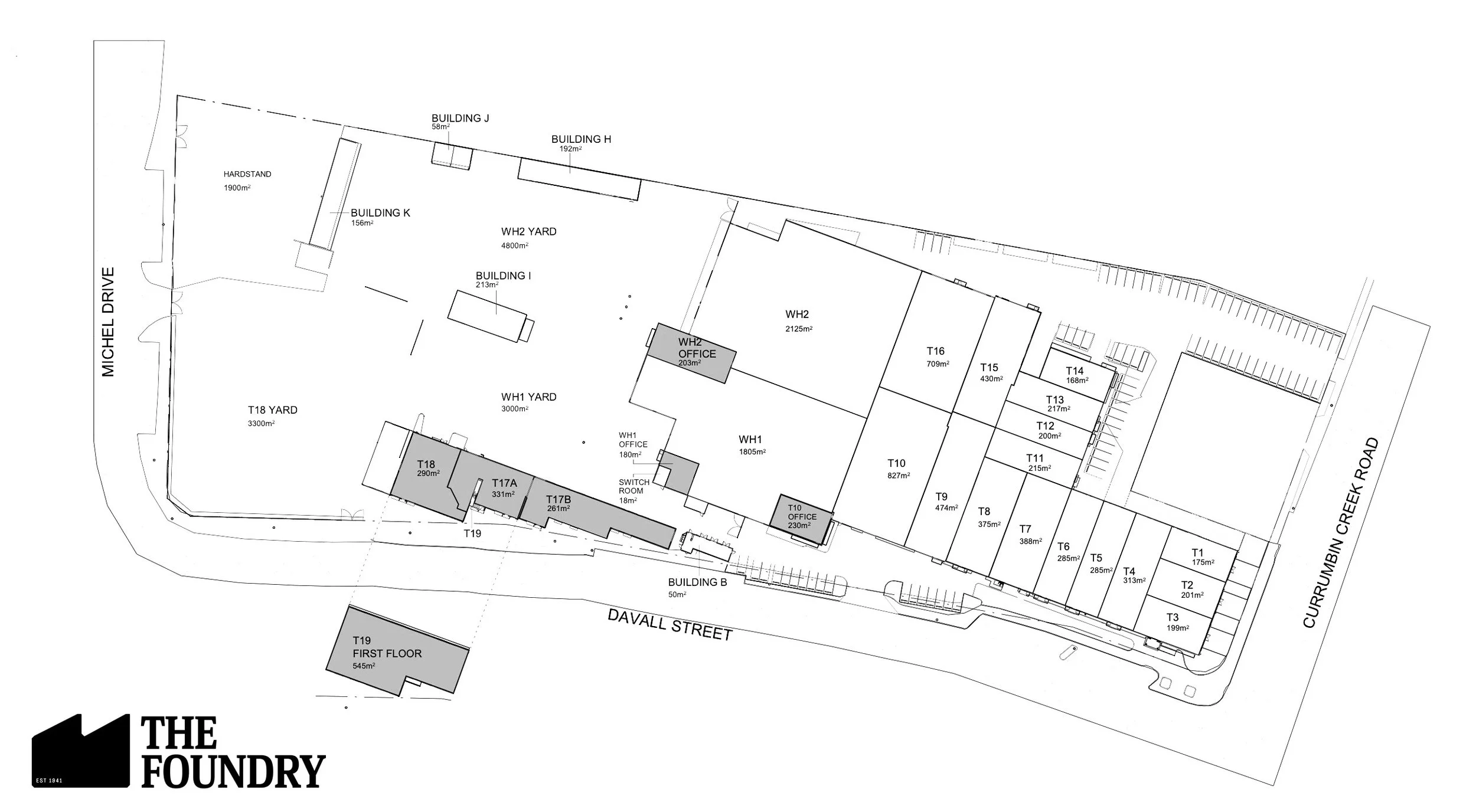 Site plan of The Foundry Currumbin with labeled buildings, yards, and streets, including structures such as warehouses, offices, and storage areas. The plan shows streets, parking, and the layout of various structures.