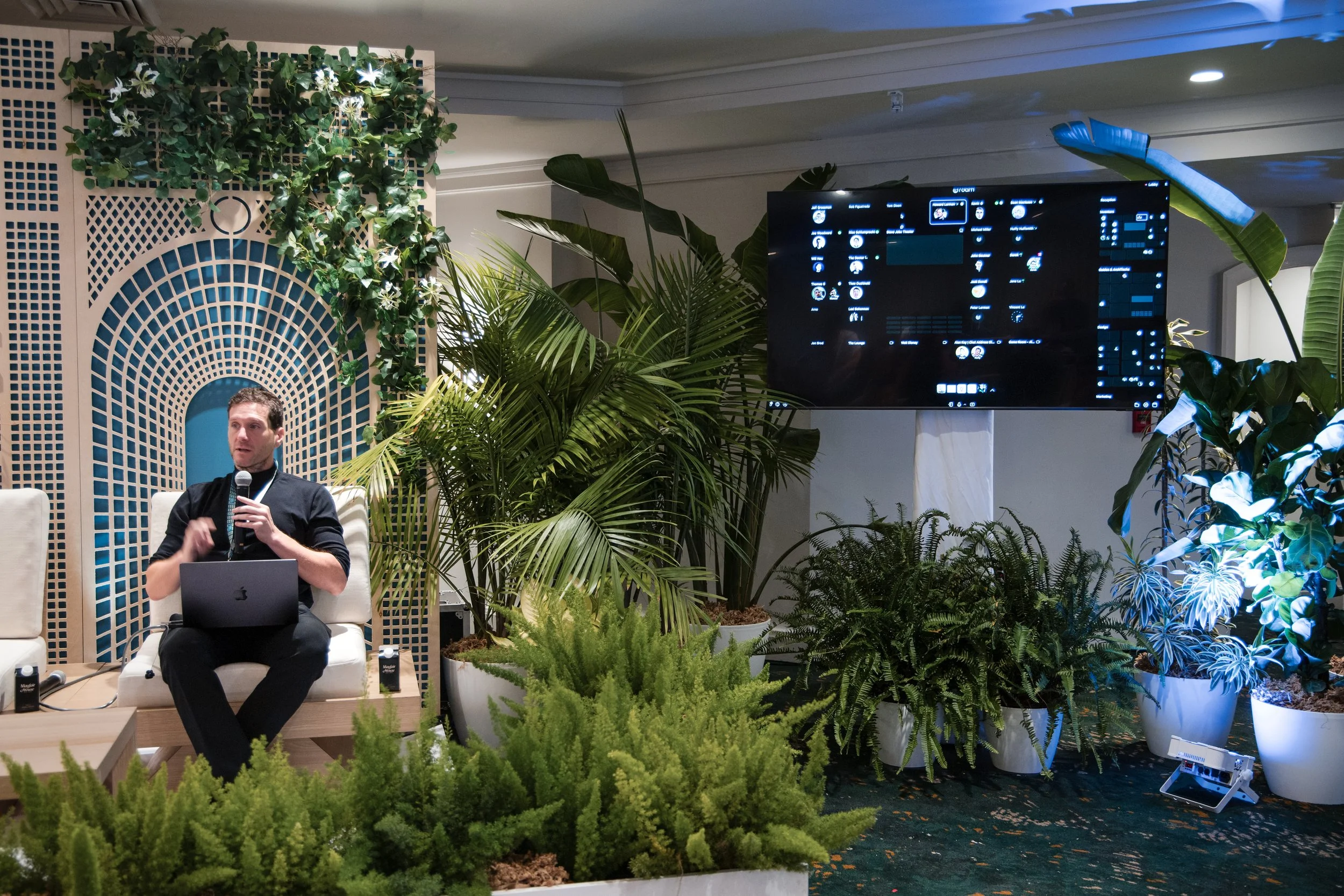 The Future of Team Collaboration: ROAM, speaking on stage at the Arrington Founders Retreat, a team member from Roam giving a briefing addressing an audience in a relaxed, retreat-like setting with soft lighting and minimal stage design. and