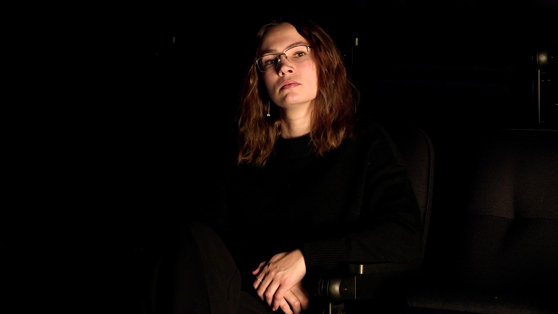 Elizabeth Laurent posing in a cinema seat