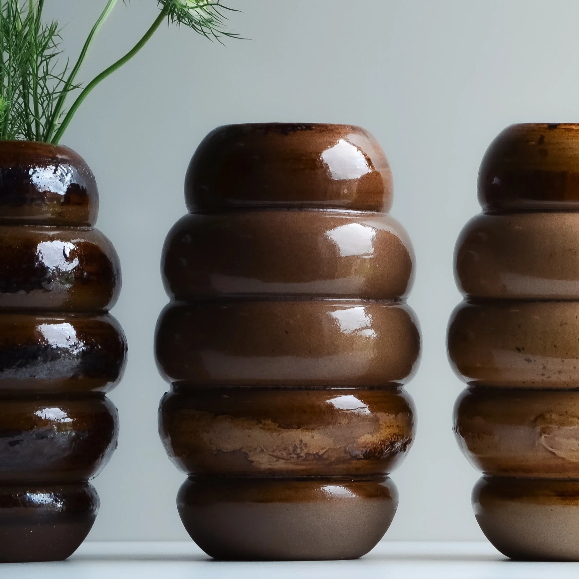 ceramic brown bud vase on white background