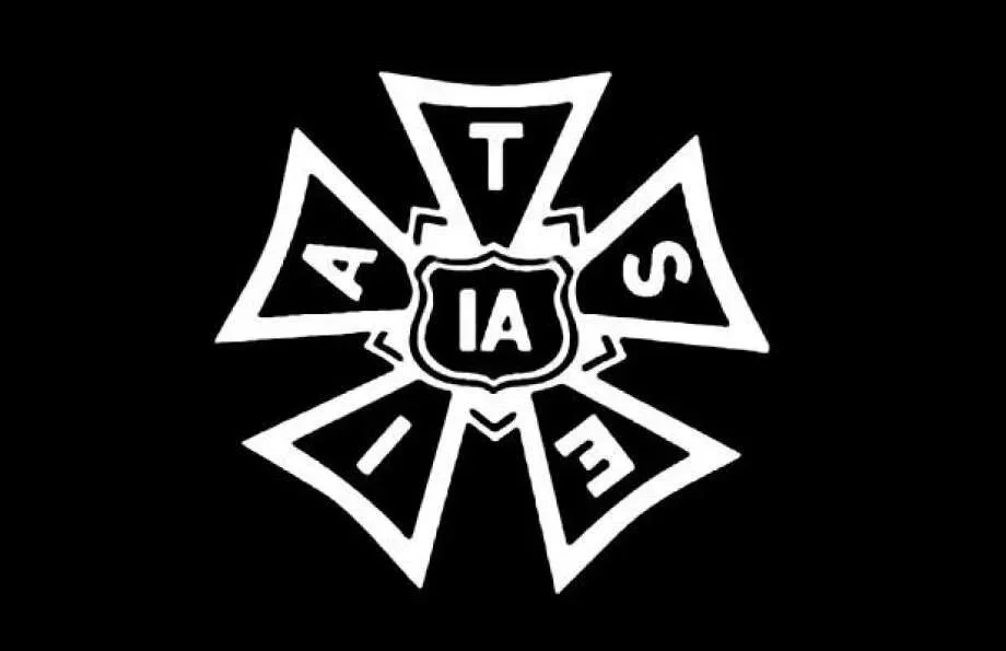 A black and white emblem featuring a central shield with the letters "IA" and surrounding text "AZTECS" arranged in a star shape.