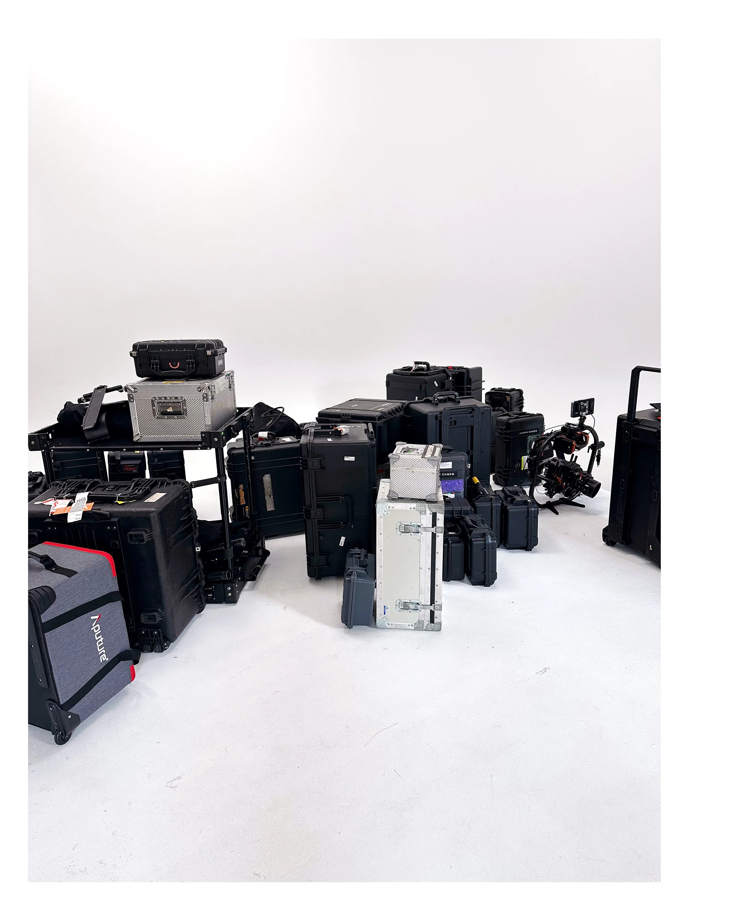A collection of professional camera equipment and cases on a white background.