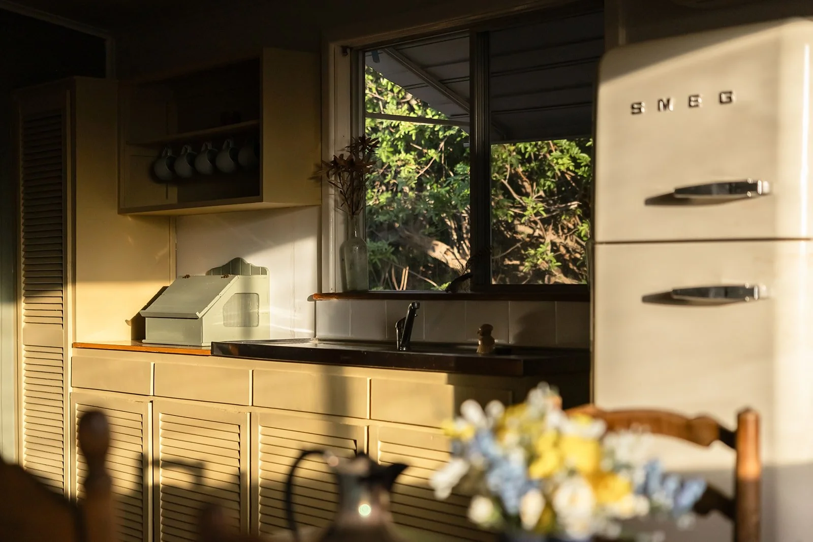 Traditional kitchen cupboards, bread box and retro fridge