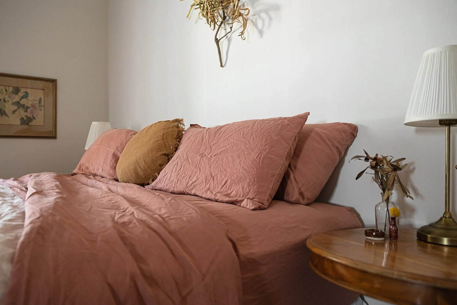 King sized bed in the main bedroom with dried banksias