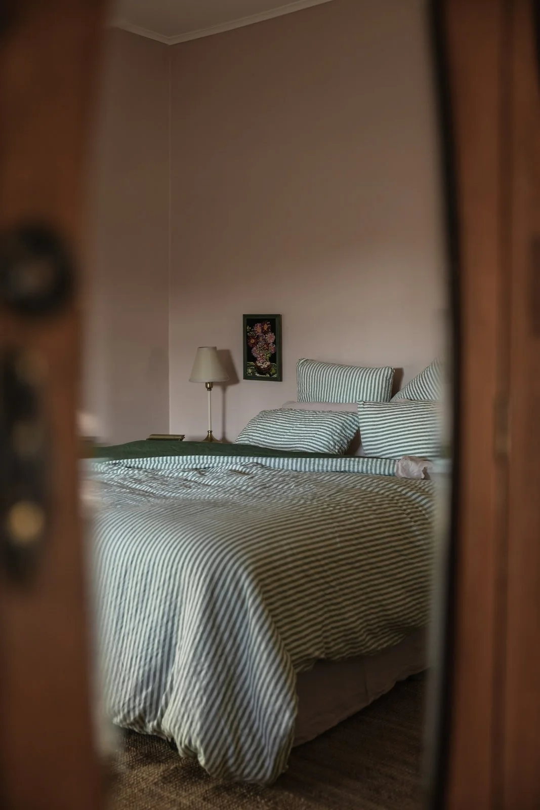 Reflection of snuggly queen sized bed a sunny hill
