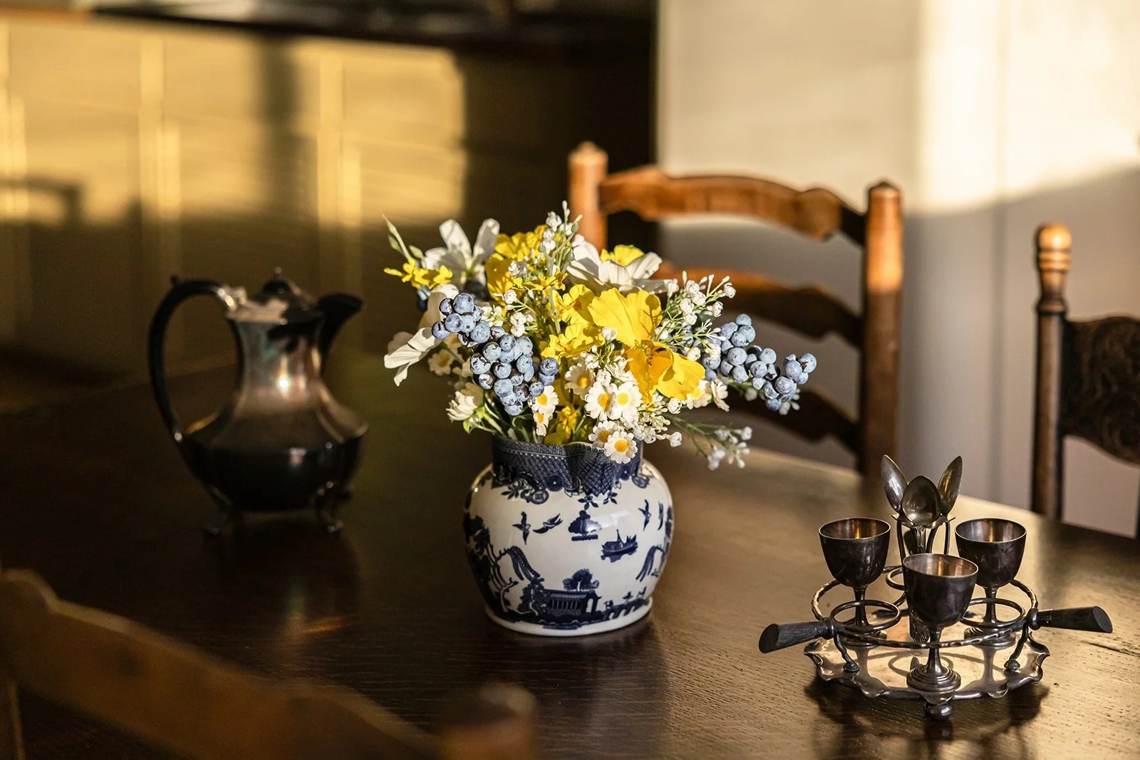 Flowers and old eggs cups on the country kitchen table at Sunny Hill in York, Western Australia