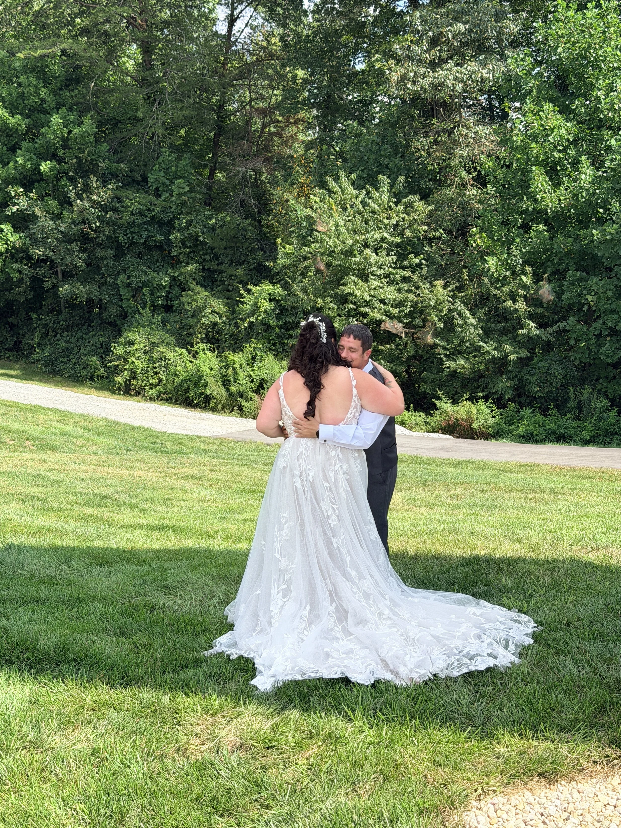 Bride and groom hugging in meadow at mountain view wedding venue;  Bride and groom at sweetheart table with flowers;  Bride and groom in meadow with gazebo at golden hour; Best Wedding Reviews Near Charlotte NC
