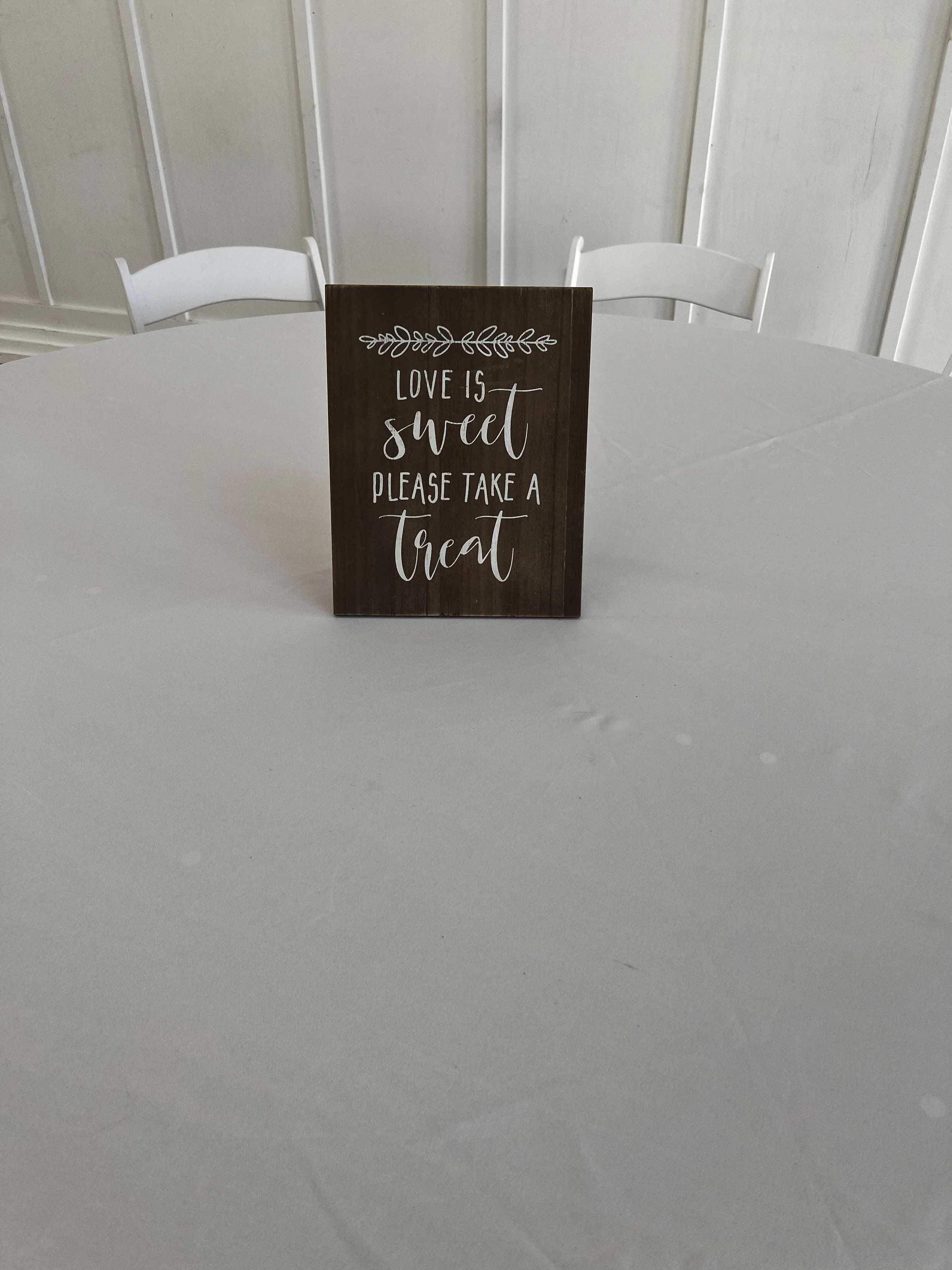 Black sign "Love is sweet. please take a treat" for Charlotte wedding venue