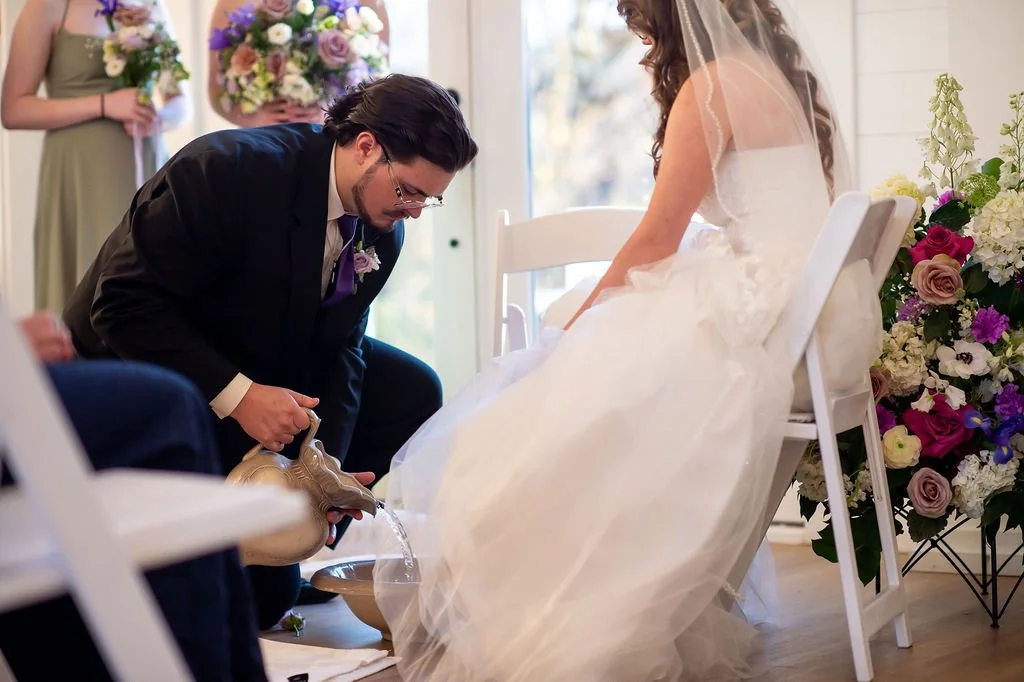 Washing of feet ceremony at white wedding venue near Charlotte NC; unique unity ceremony ideas near Charlotte NC