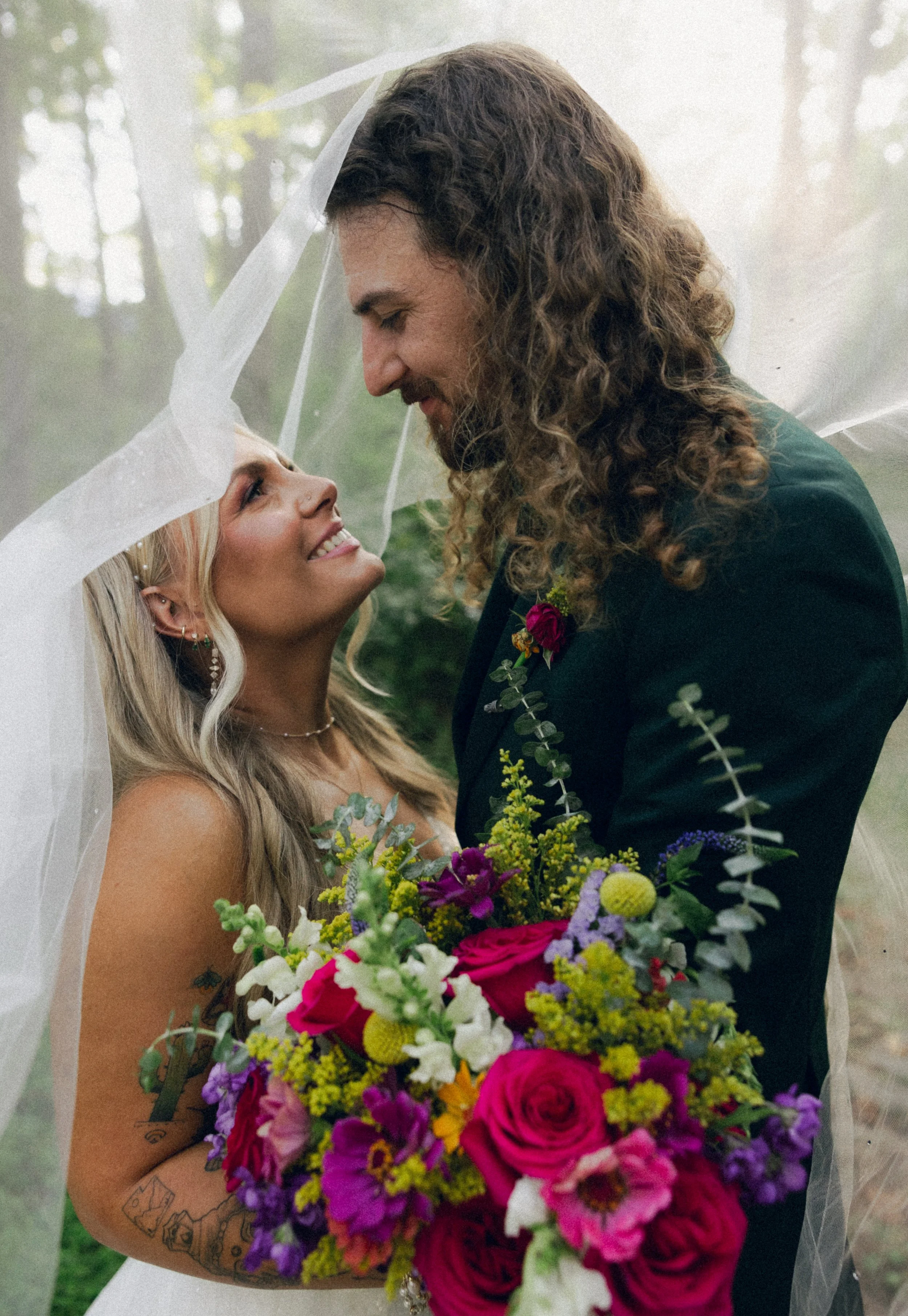 Bride and groom under veil at Immersive weekend wedding