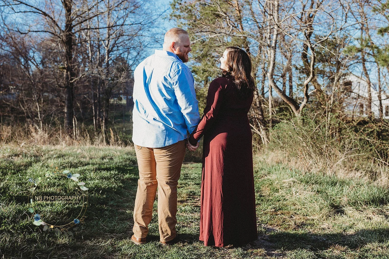 engaged couple holding hands in meadow at Charlotte wedding venue: truth about free wedding websites