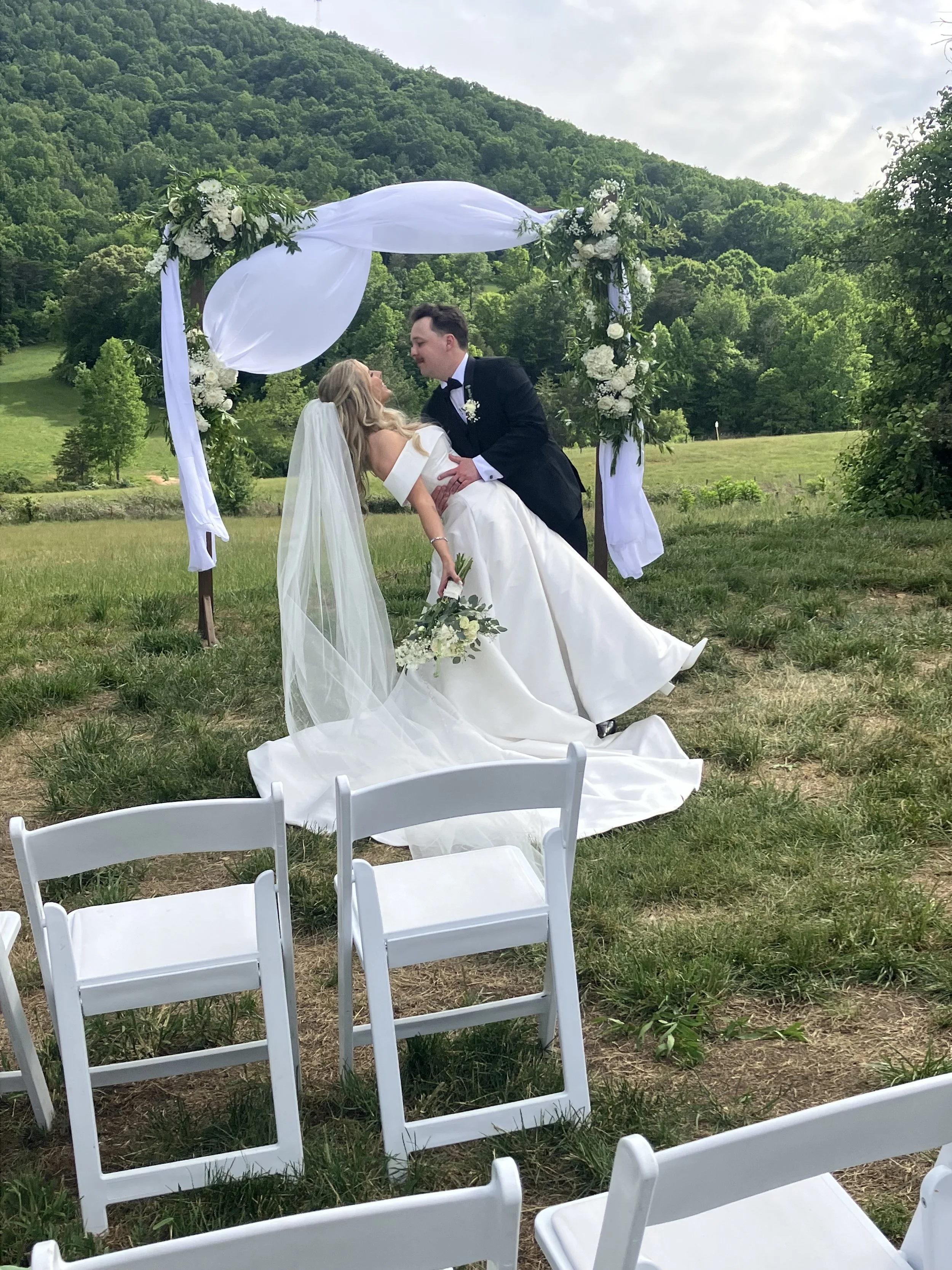 Groom dipping bride at mountain view wedding ceremony near Charlotte