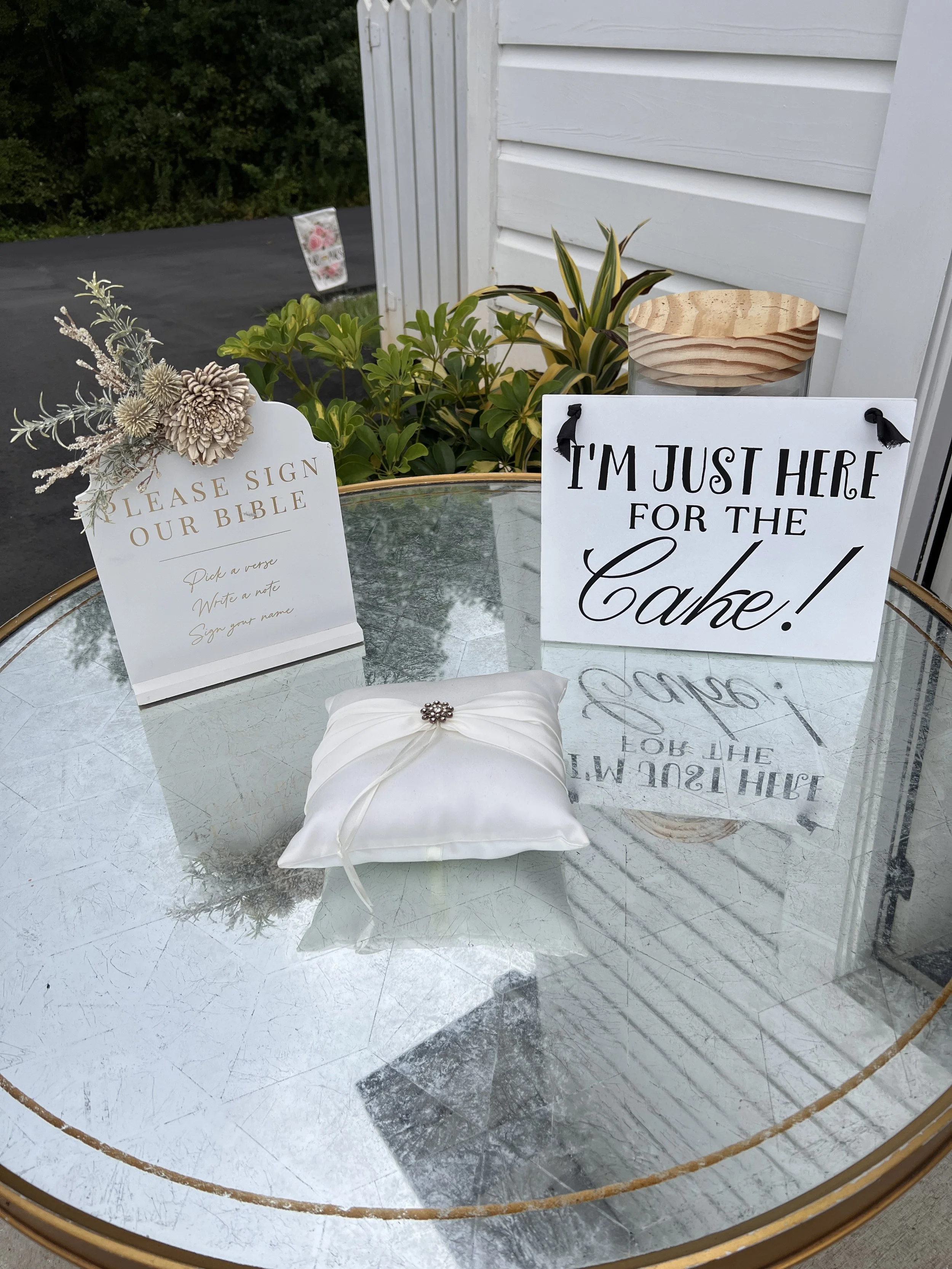 Assorted wedding signs and ring bearer pillow