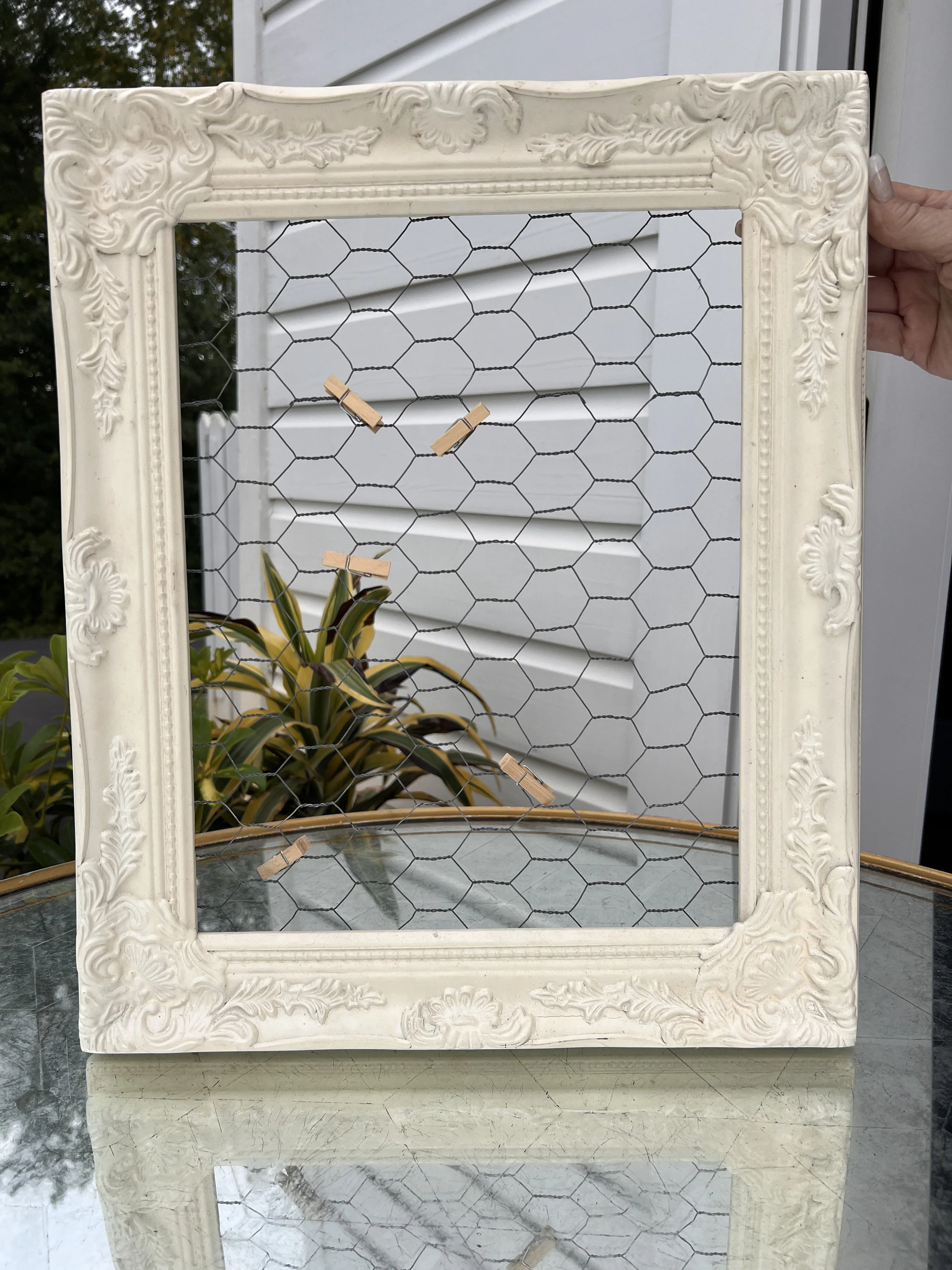 Cream decorative frame with mesh and clothespins for pictures for wedding decorations