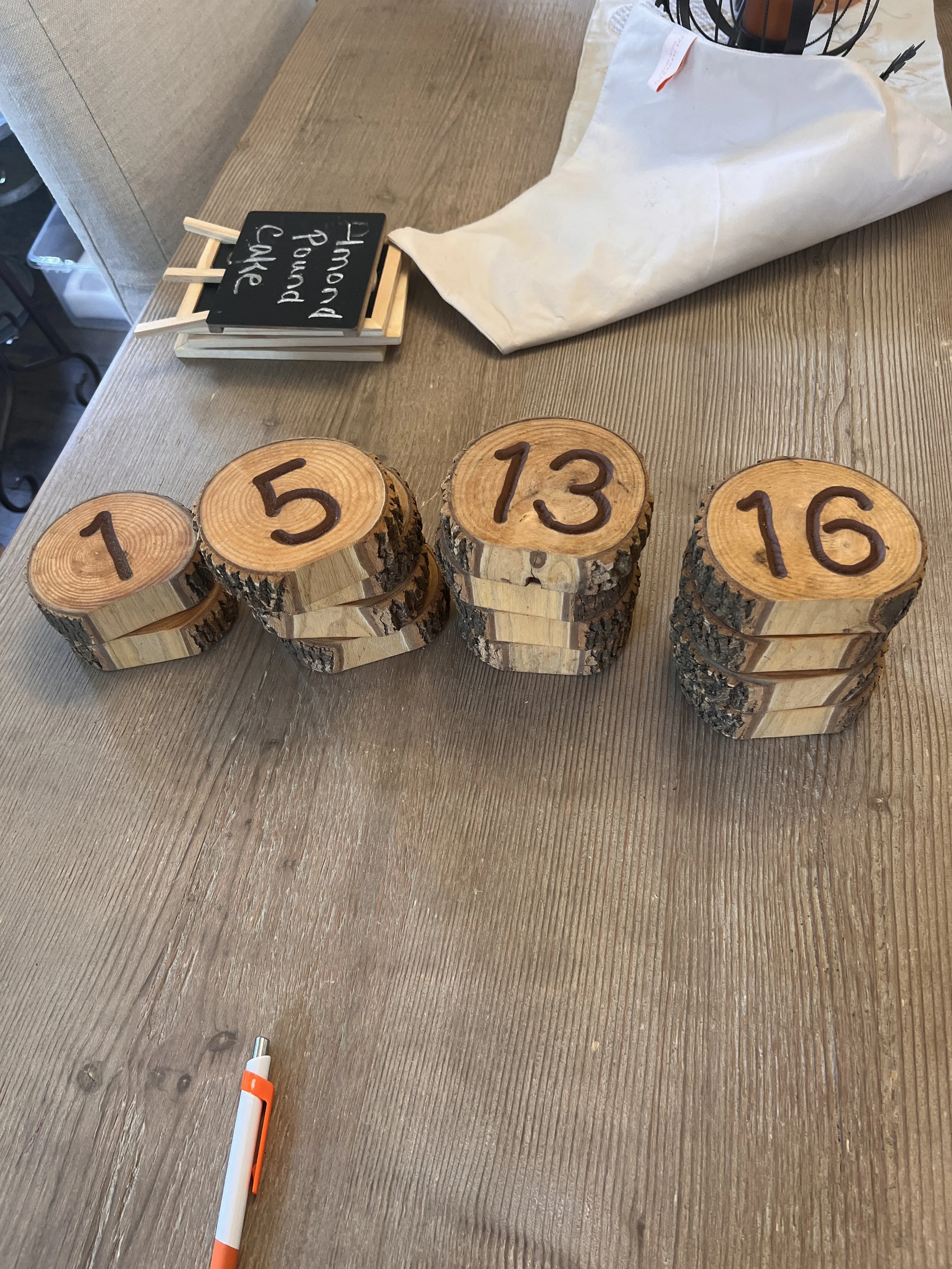 Live edge wood table numbers at Charlotte wedding venue