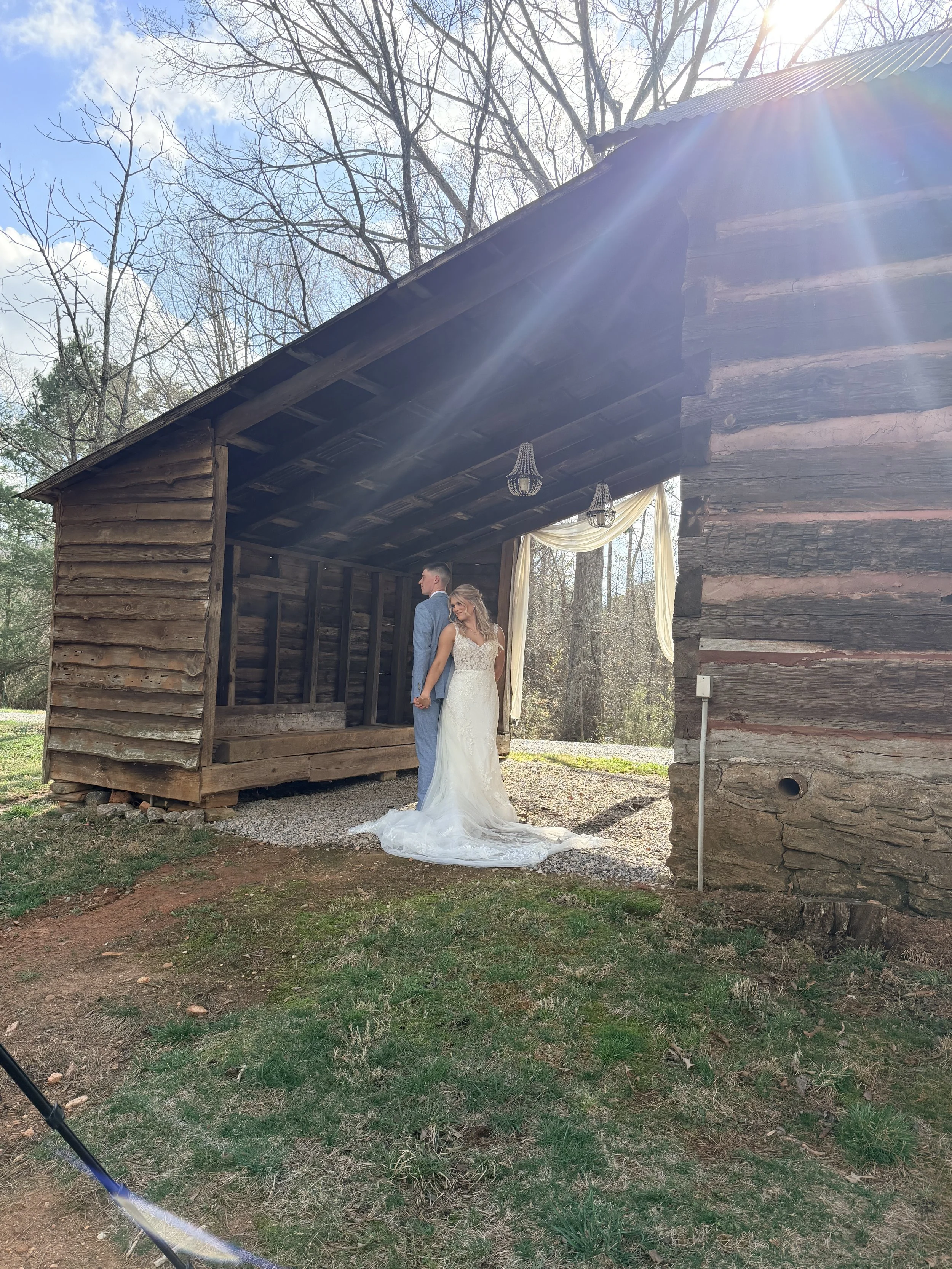bride and groom in historic tobacco barn; best wedding venues near Charlotte NC for mountain views