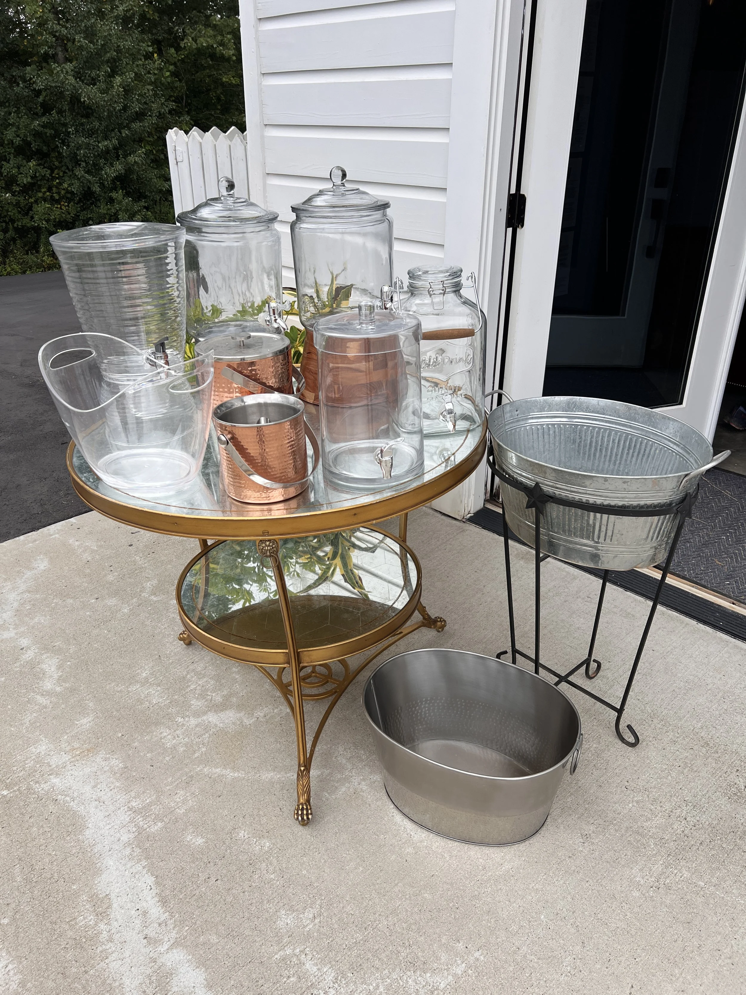 Assorted drink containers, ice buckets, drink holders for bar at wedding