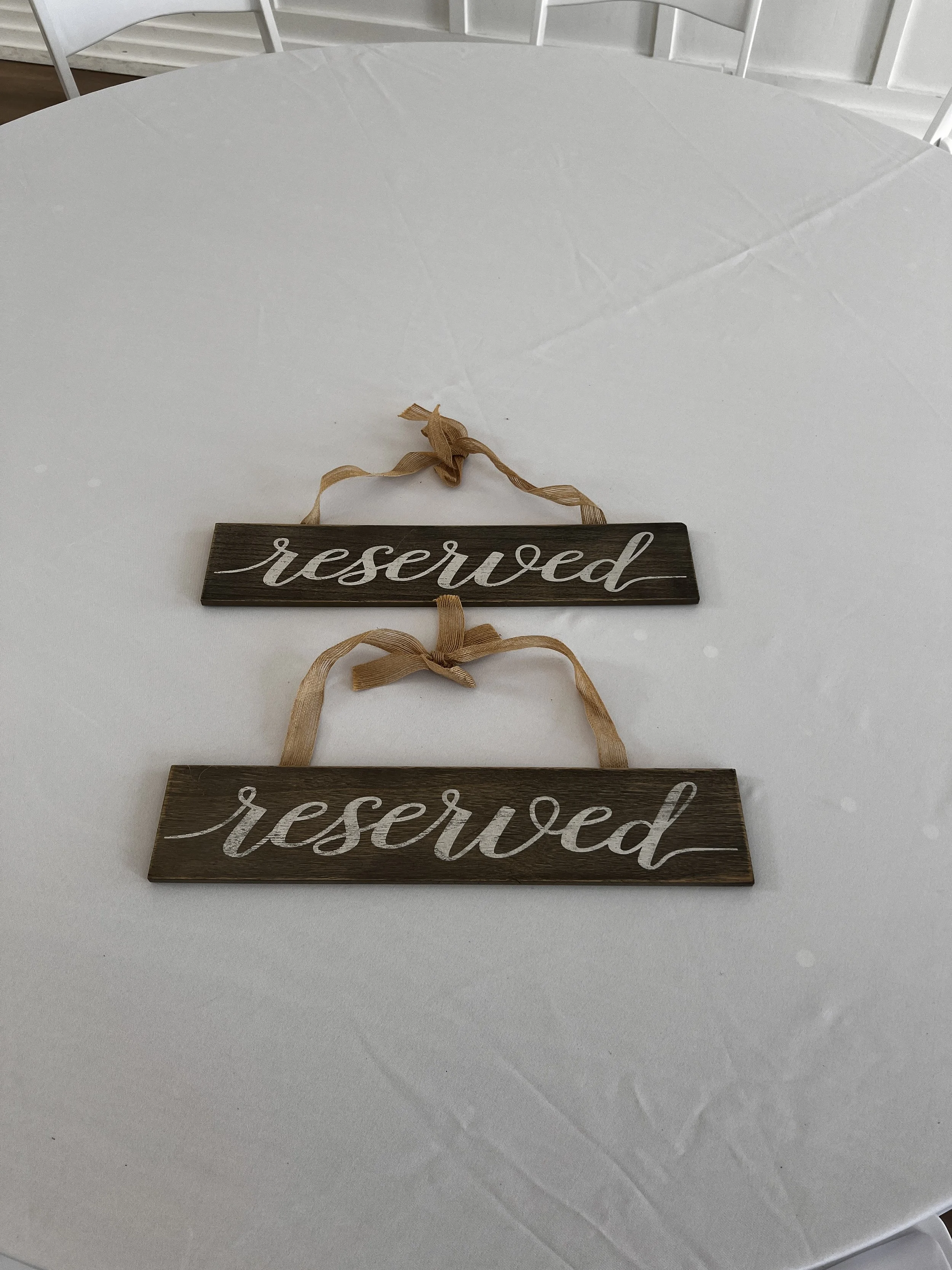 Brown wooden "Reserved" signs for Charlotte wedding