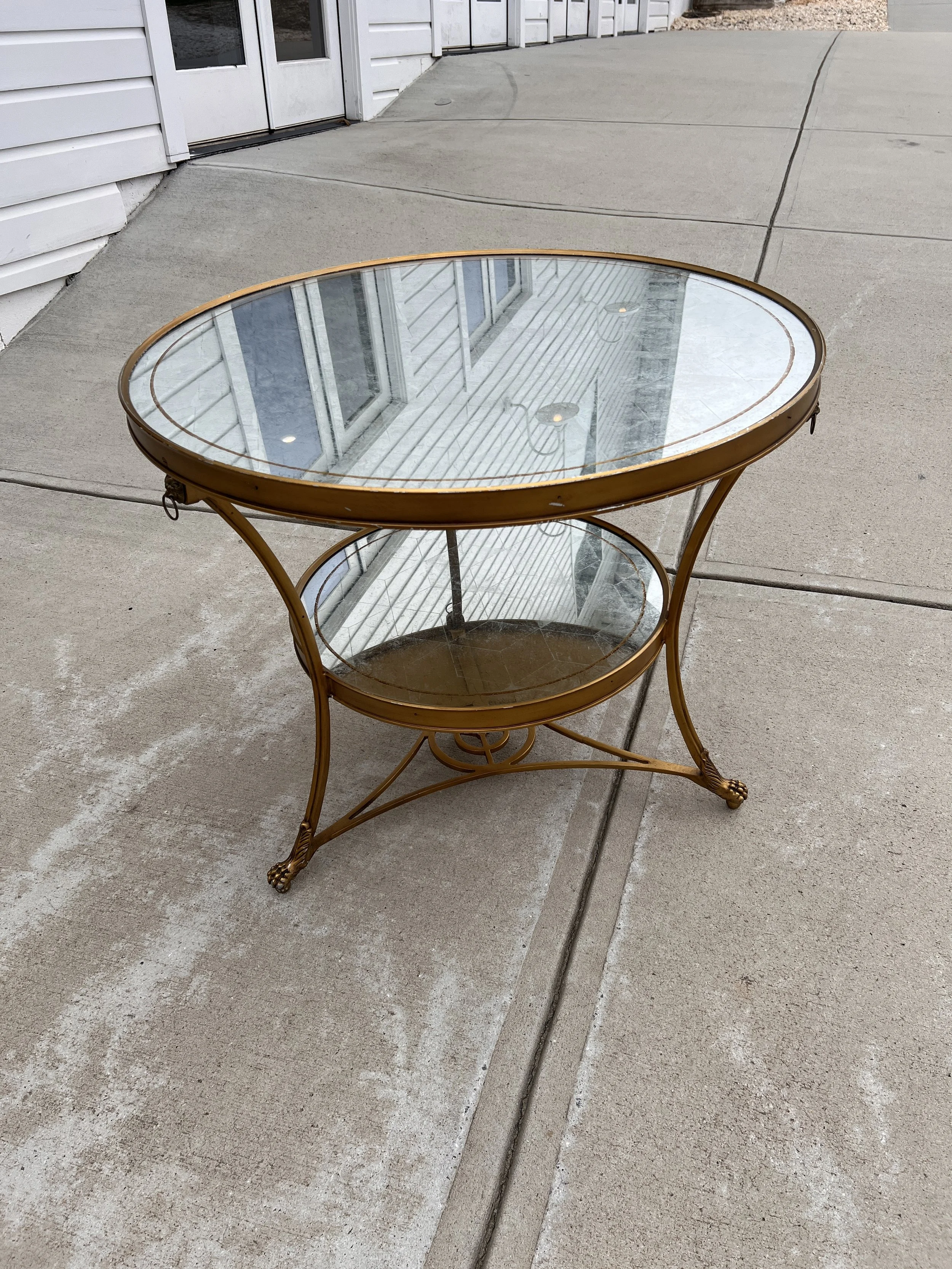Gold round table with crackle mirror top and shelf
