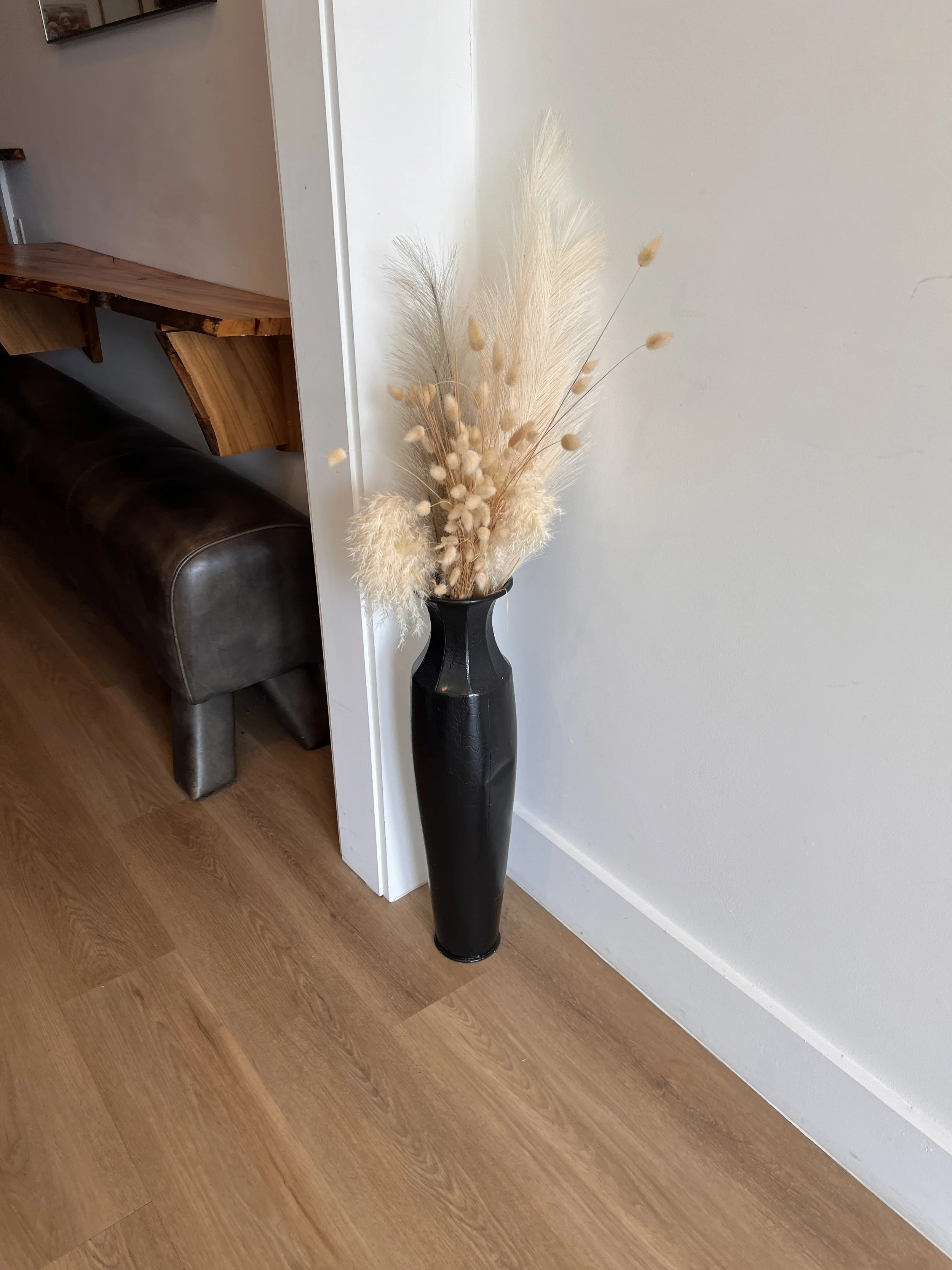 Tall black vase with boho style pampas grass for wedding decorations