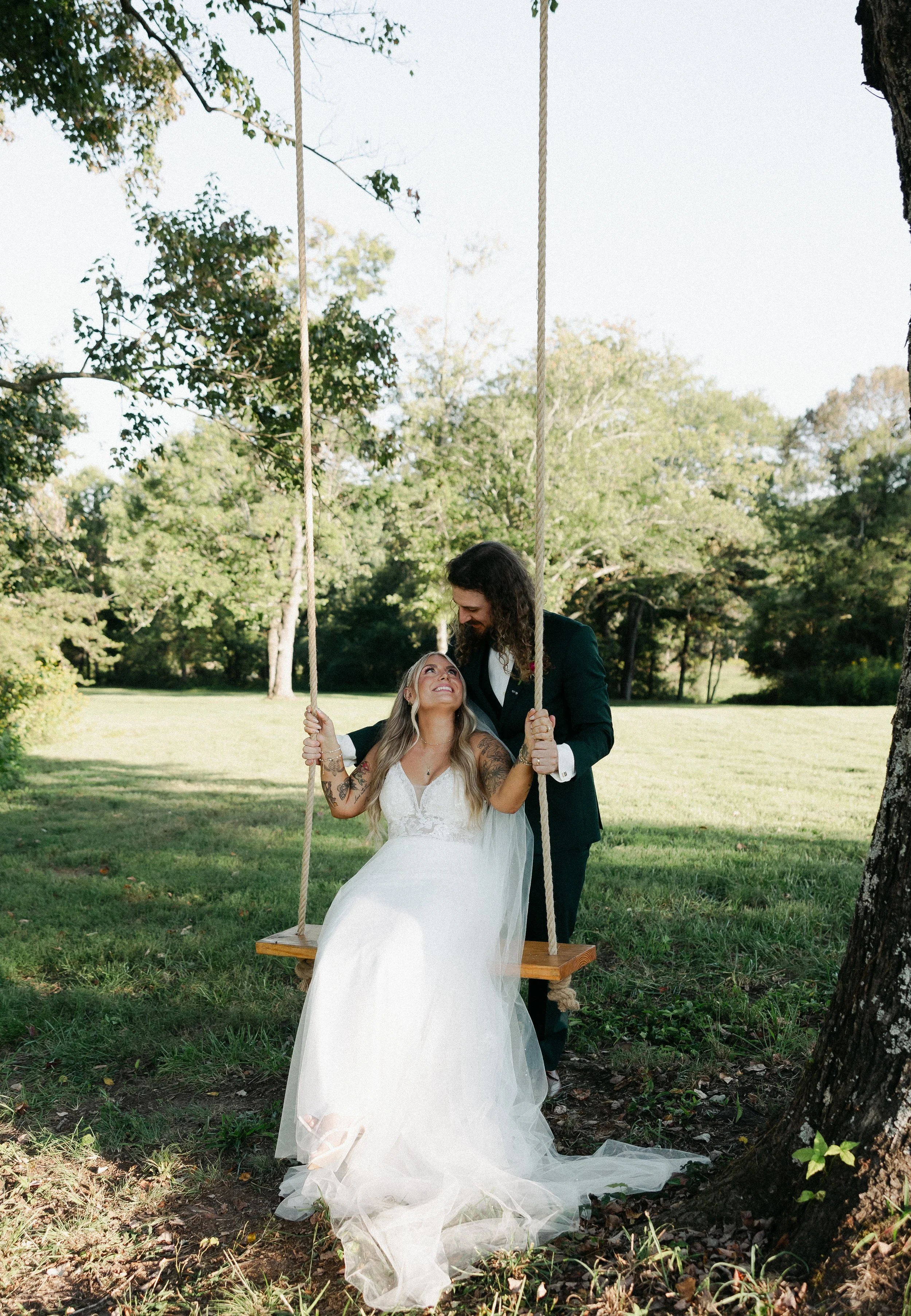 Bride and groom on tree swing at Charlotte wedding venue