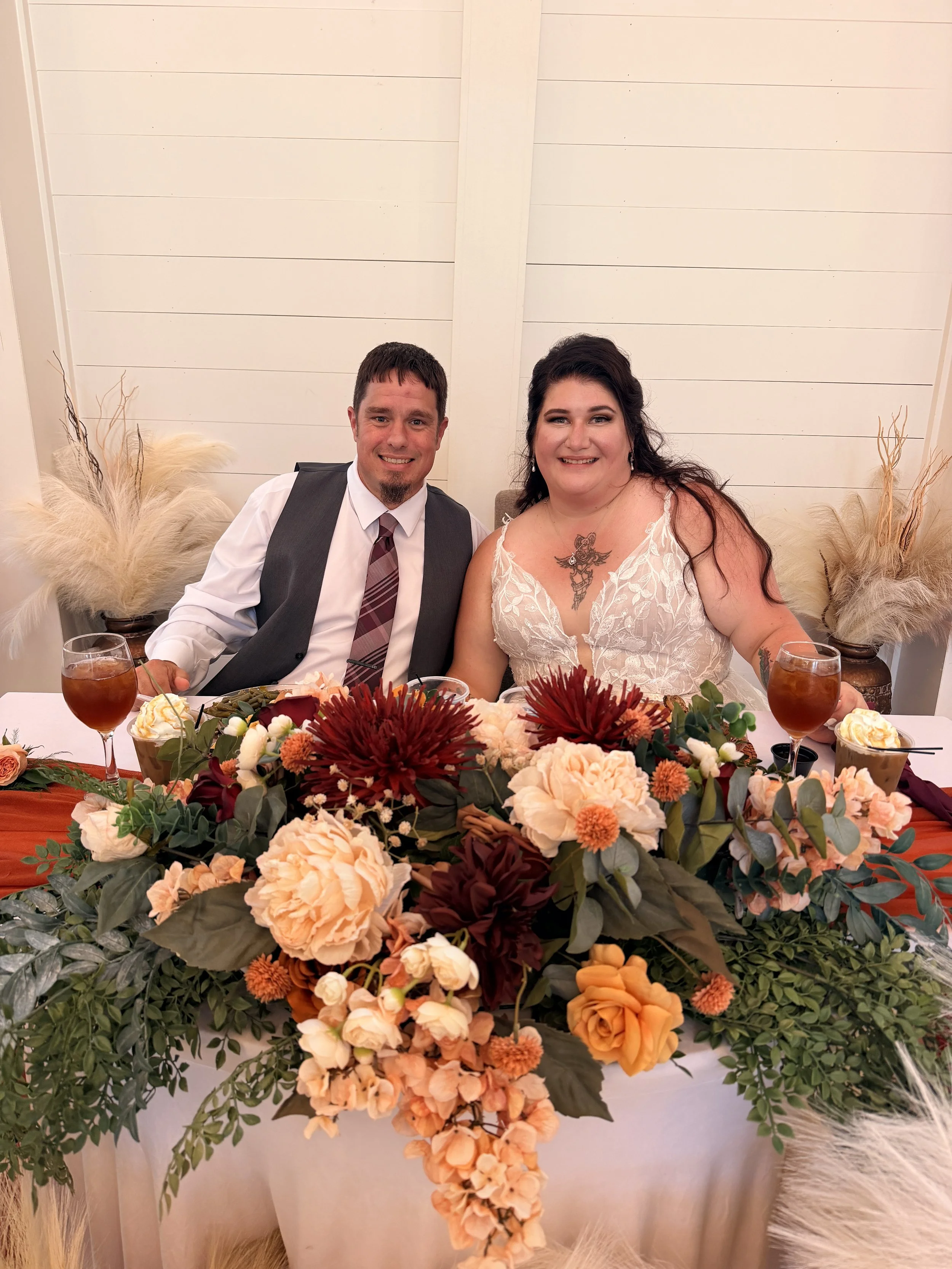 Bride and groom at sweetheart table with flowers;  Bride and groom in meadow with gazebo at golden hour; Best Wedding Reviews Near Charlotte NC