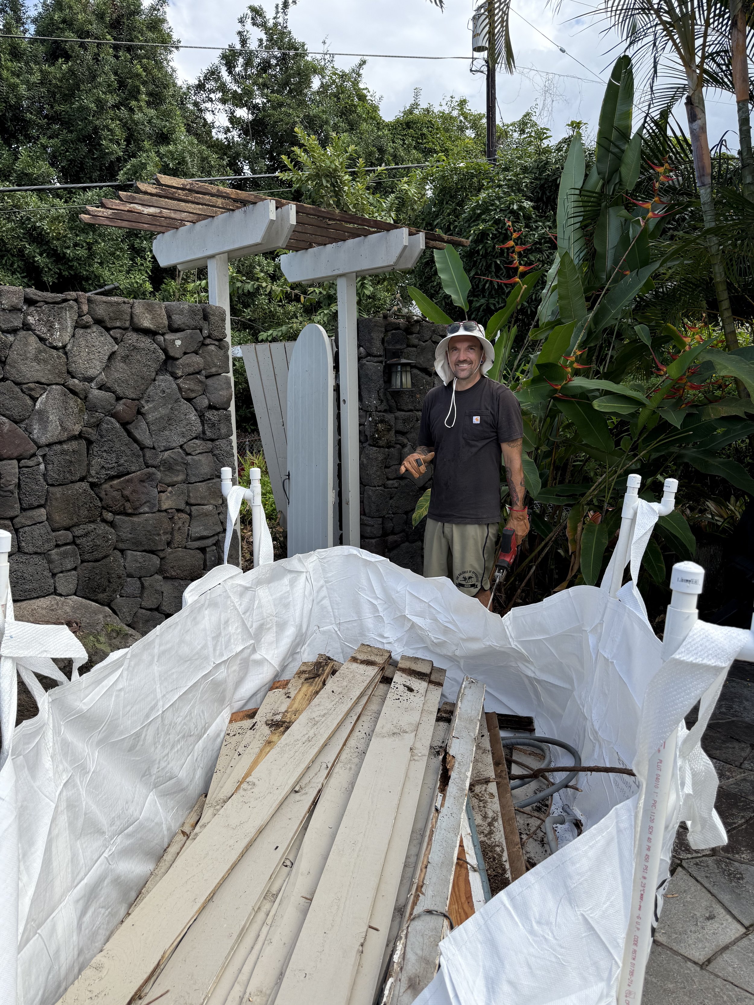 Filling up dumpster with rotten fencing plus all rotten railing and bench wood. 
