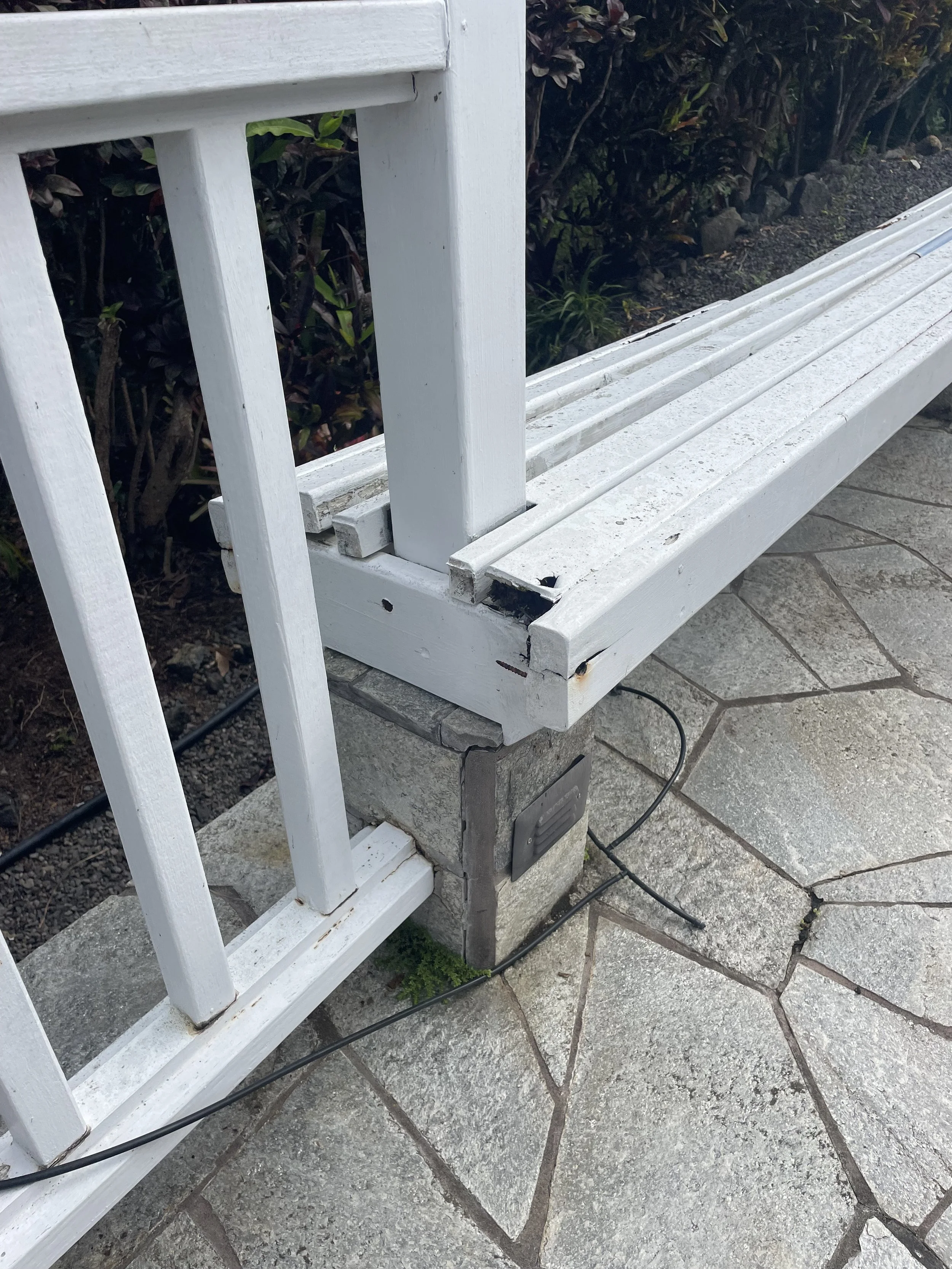 Rotten footings of bench and railing.