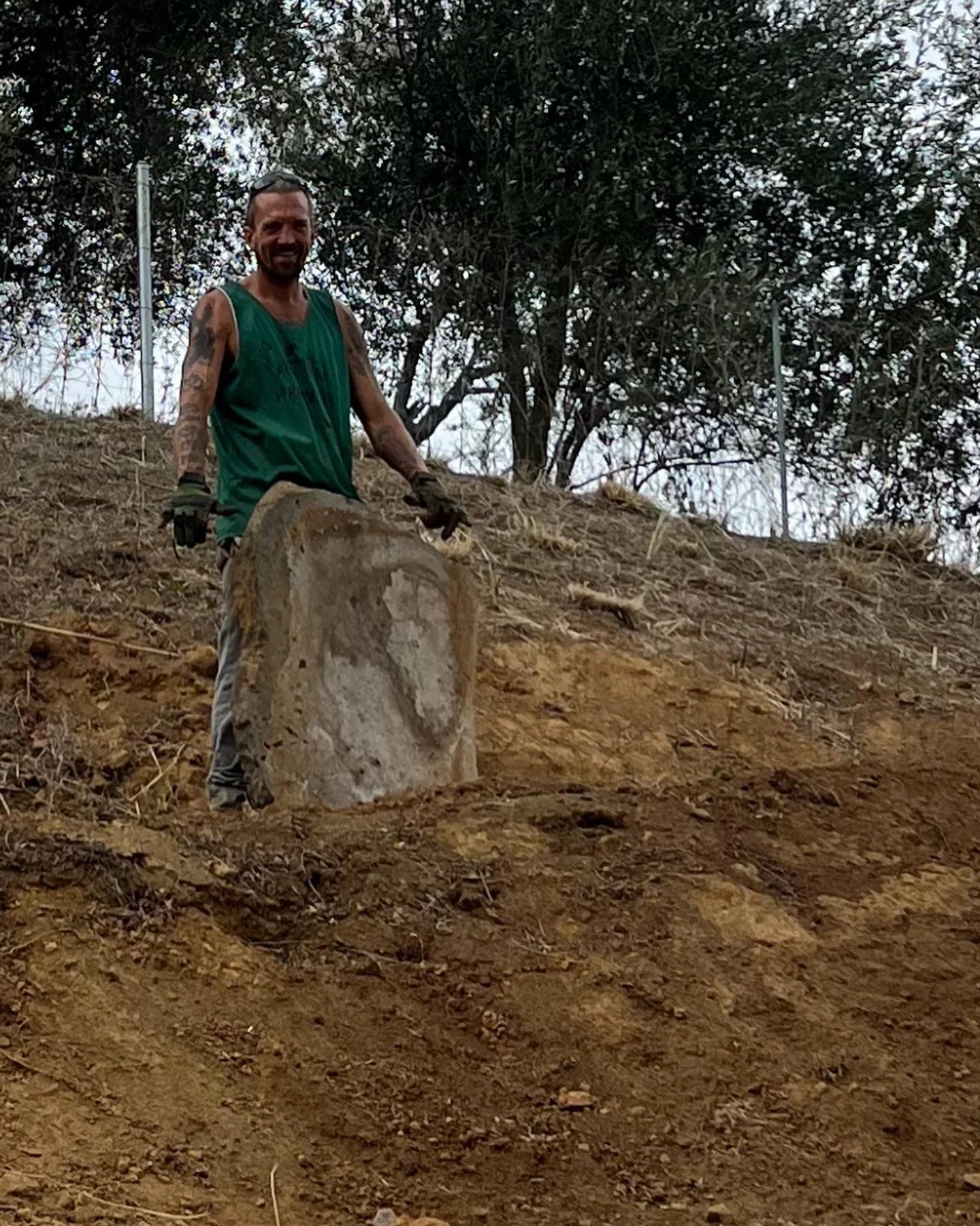 Joey carrying & placing 50lbs pavers for landing on opposite side of amphitheater.