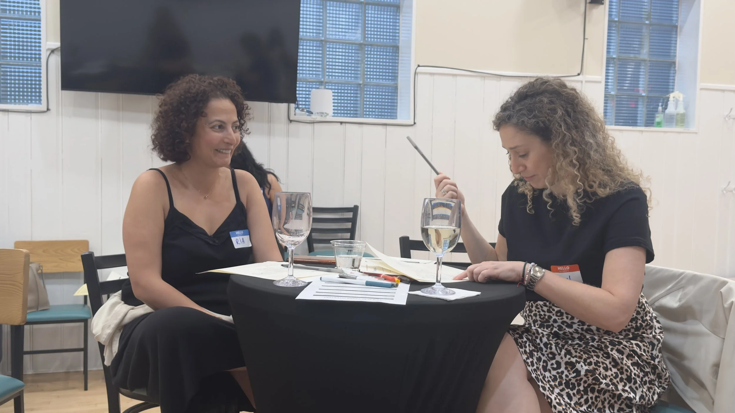 Two women chatting over curated drinks during a corporate and entrepreneurial mothers networking social hours.