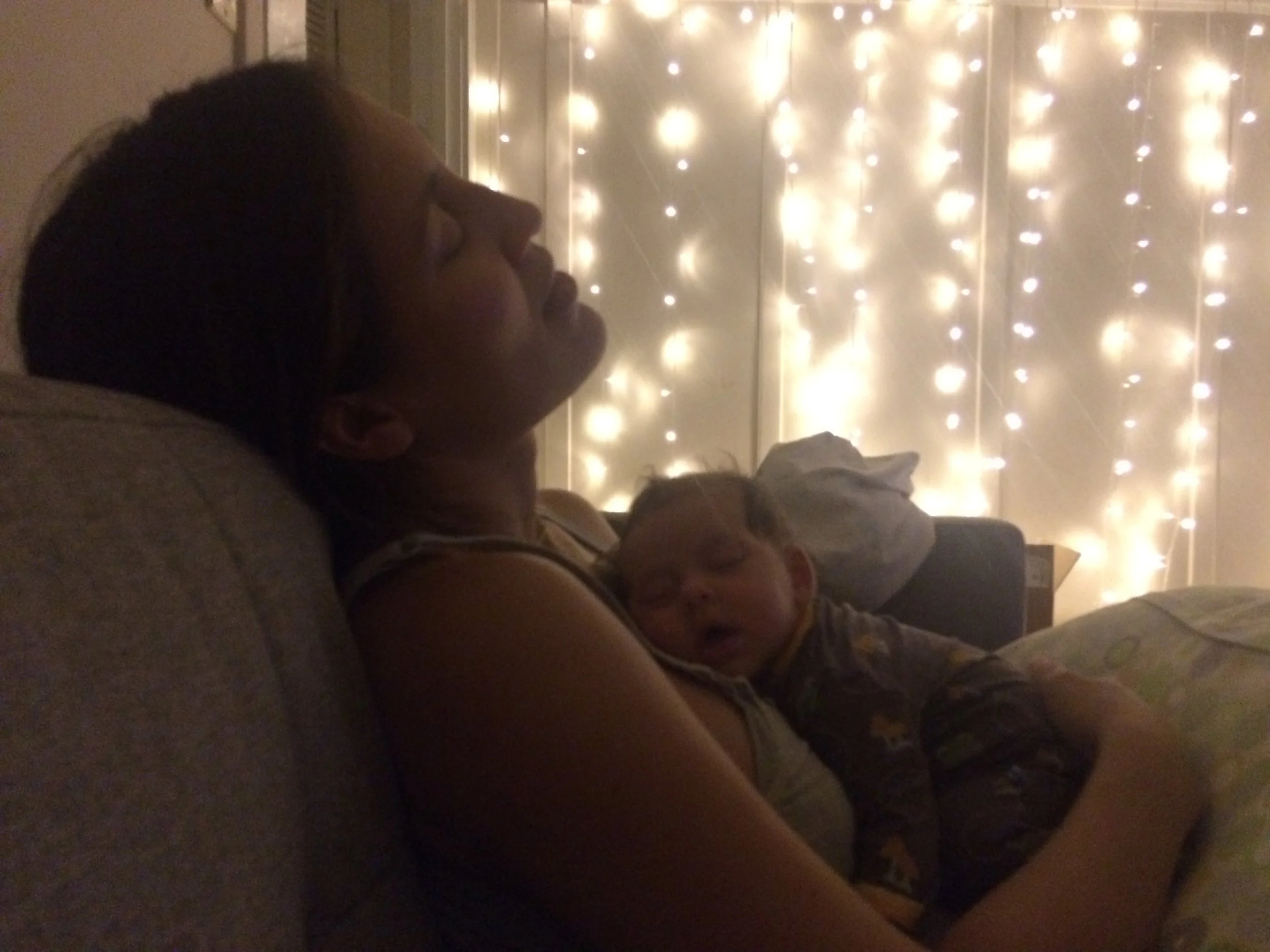 A darkened background image of a mother holding her baby close, setting an introspective tone for a discussion on matrescence and identity.