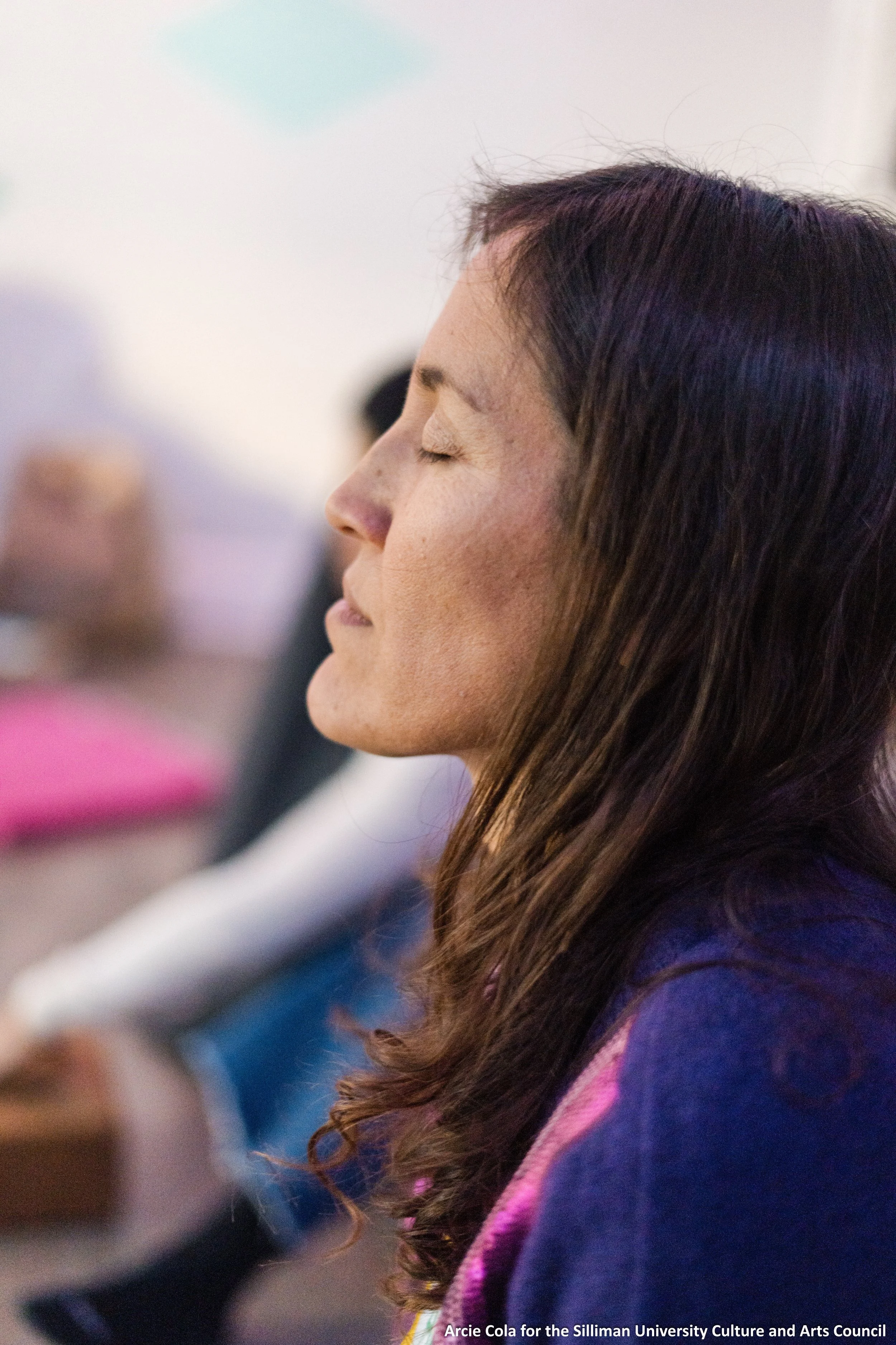 A close-up profile view of working moms coach Andi Salcedo with eyes closed in a calm, meditative state, representing grounding and life realignment.
