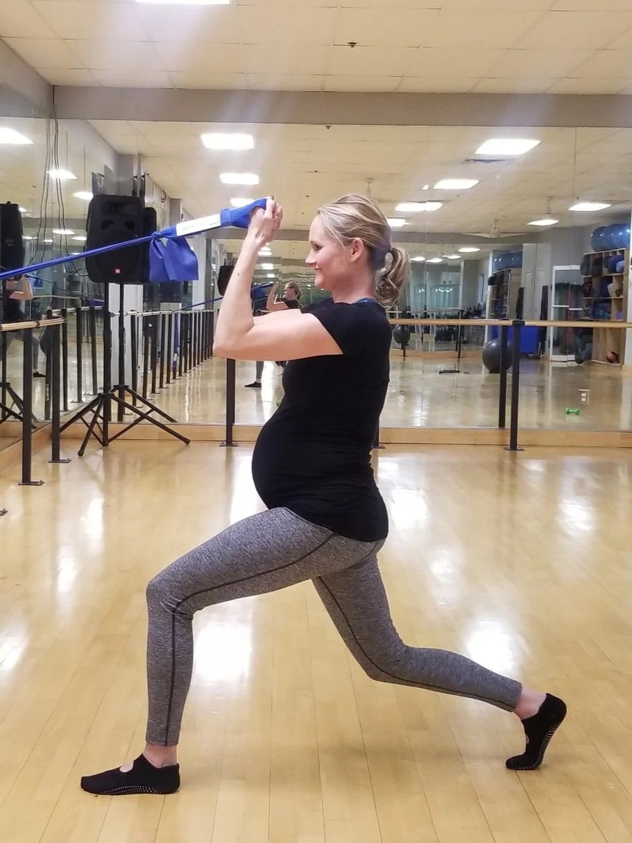 A pregnant woman exercising with bootybarre sculpt bands at North Little Rock Athletic Club.