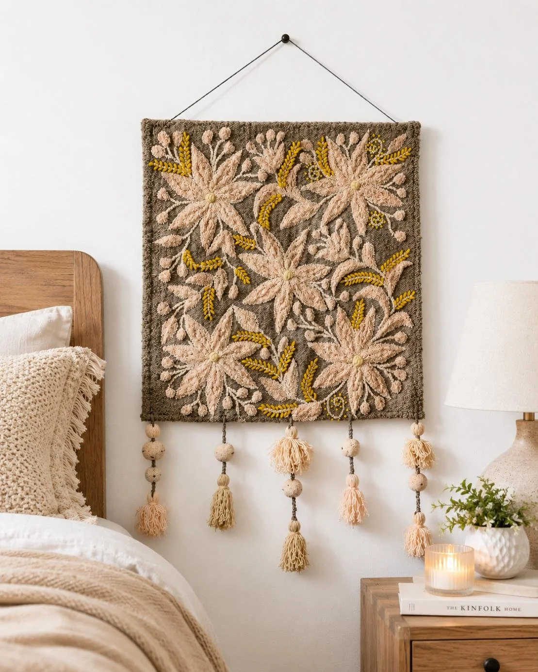 Neutral hand-embroidered wool wall hanging with cream botanical flowers, golden details, beads, and tassels.jpg