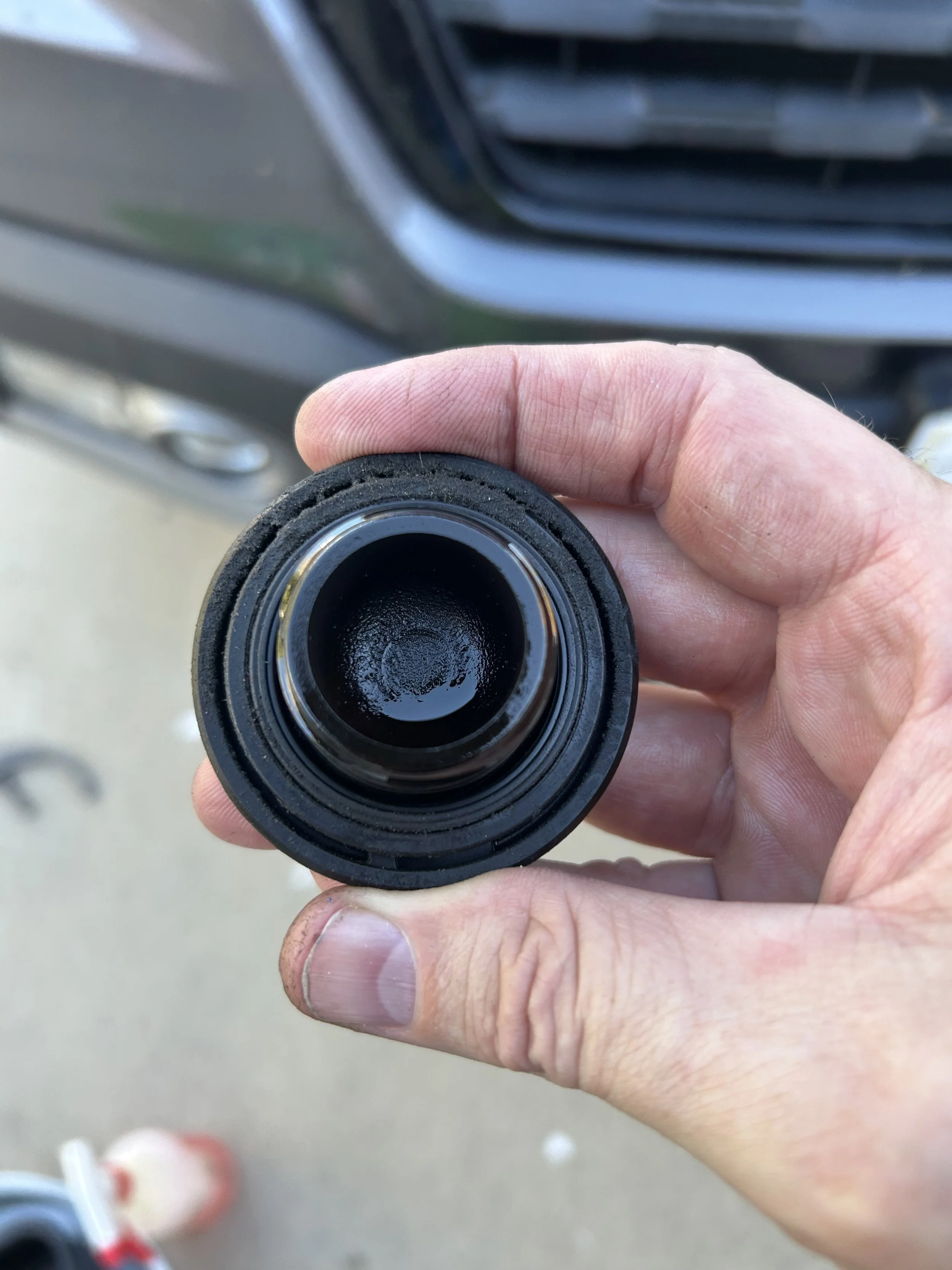 This is an image of a dirty oil cap from a second generation Ridgeline that we are seeing if it can cleaned up with valvoline restore and protect