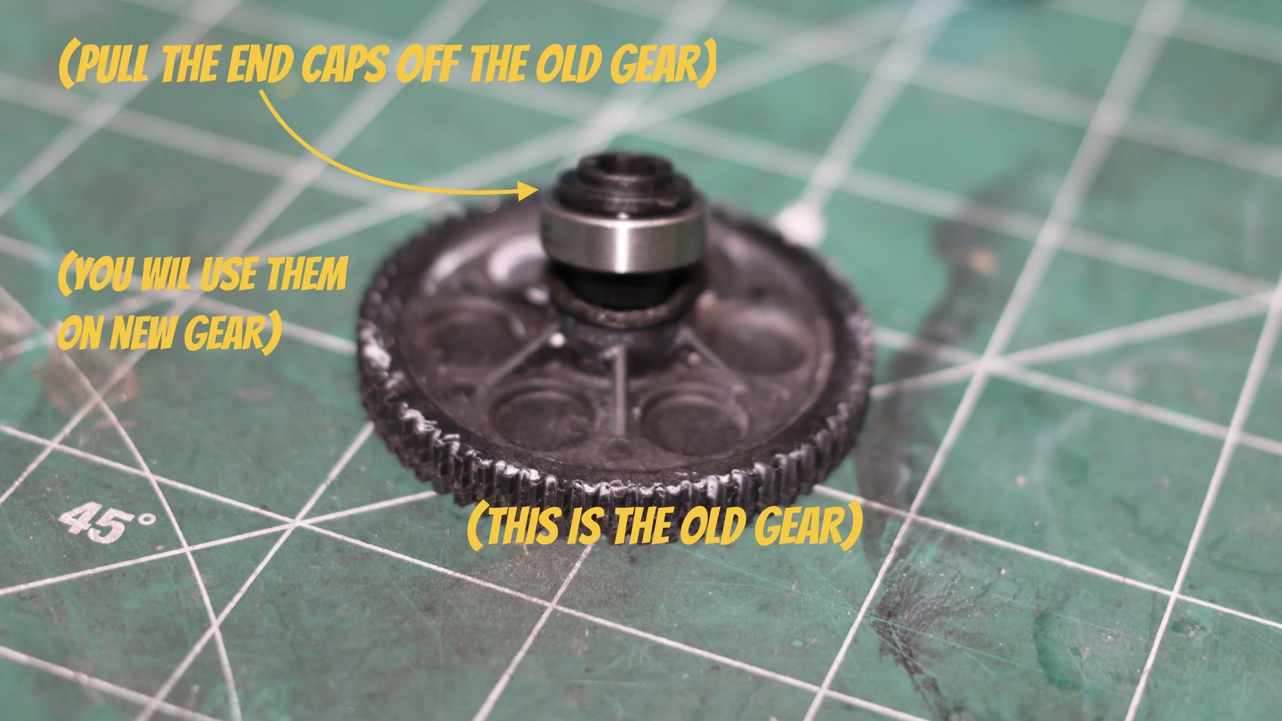 Old spur gear from arrma fury sitting on table